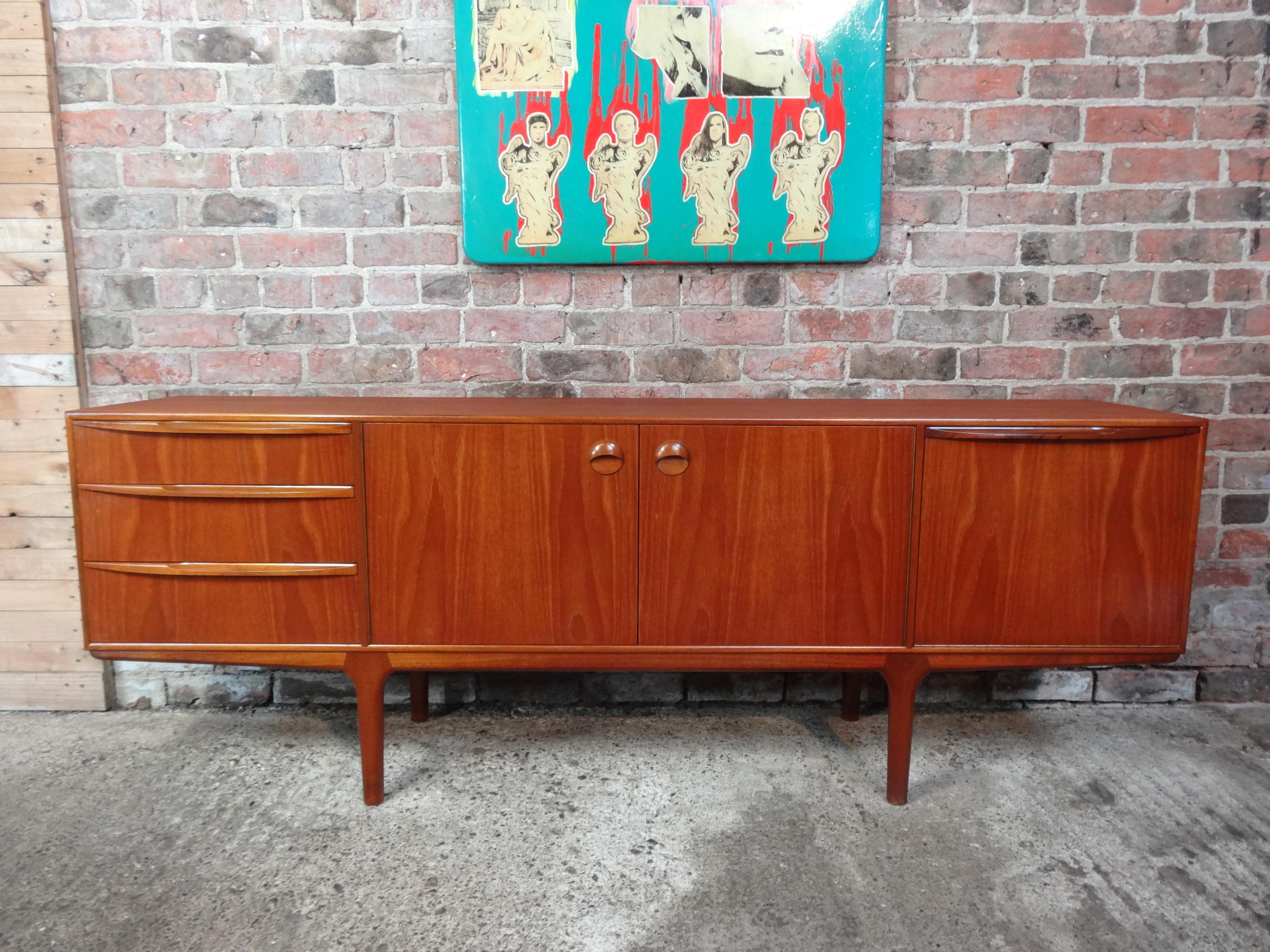Vintage 1960s McIntosh sideboard by Tom Robertson. It has three drawers, cupboard space with lovely round handles, and a drinks section with a useful pullout shelf. Credenza is in very good original condition.