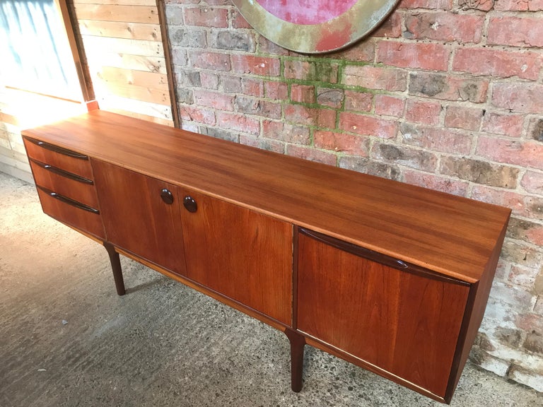 Vintage 1960s McIntosh sideboard by Tom Robertson. It has three drawers, cupboard space with lovely round handles, and a drinks section with a useful pull-out shelf. Credenza is in very good original condition.