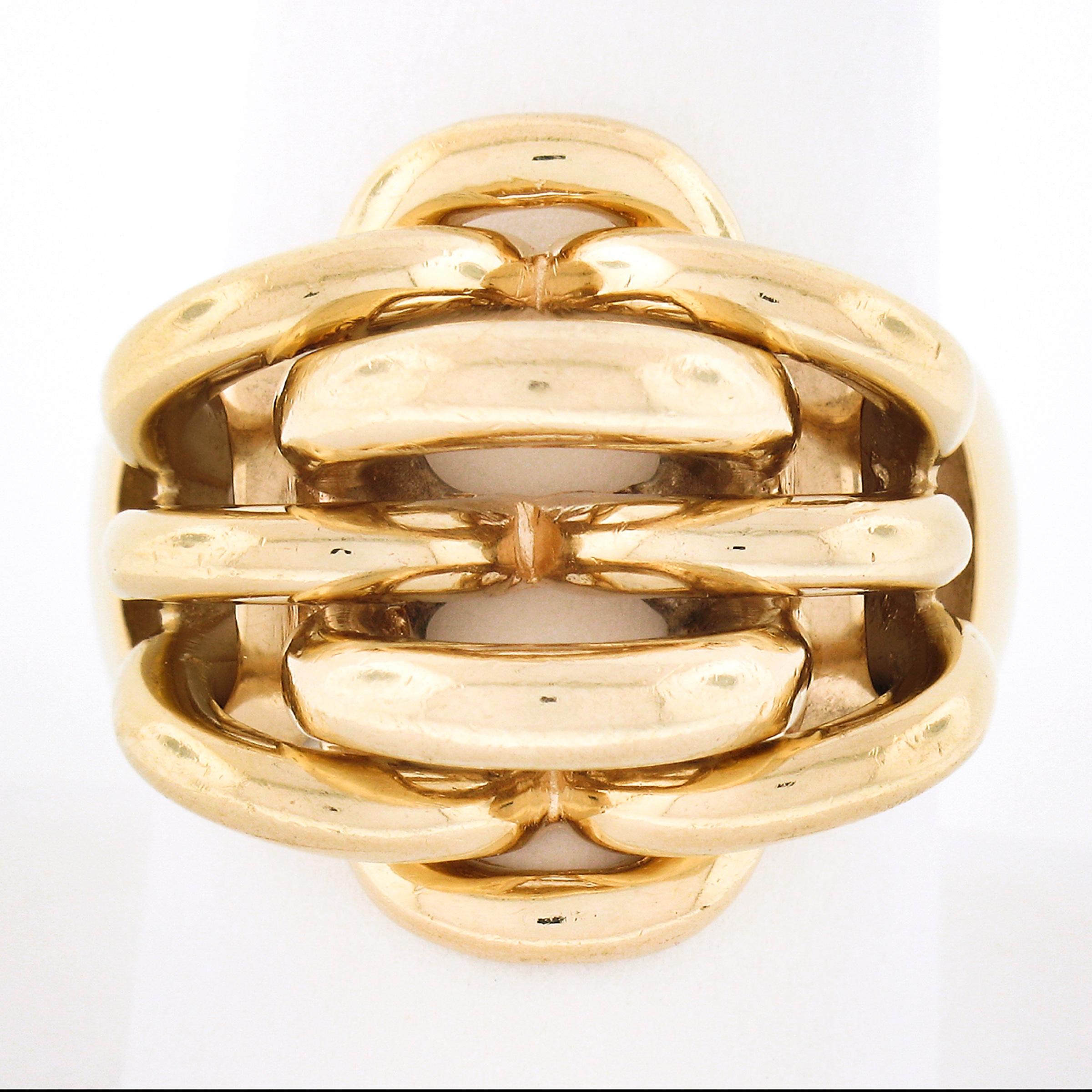 This bold and unique Retro Tiffany & Co. vintage ring is crafted in solid 14k rosy yellow gold. It features a highly polished interlocking woven pattern. The wide ring comes in excellent overall condition and it will definitely make a beautiful add