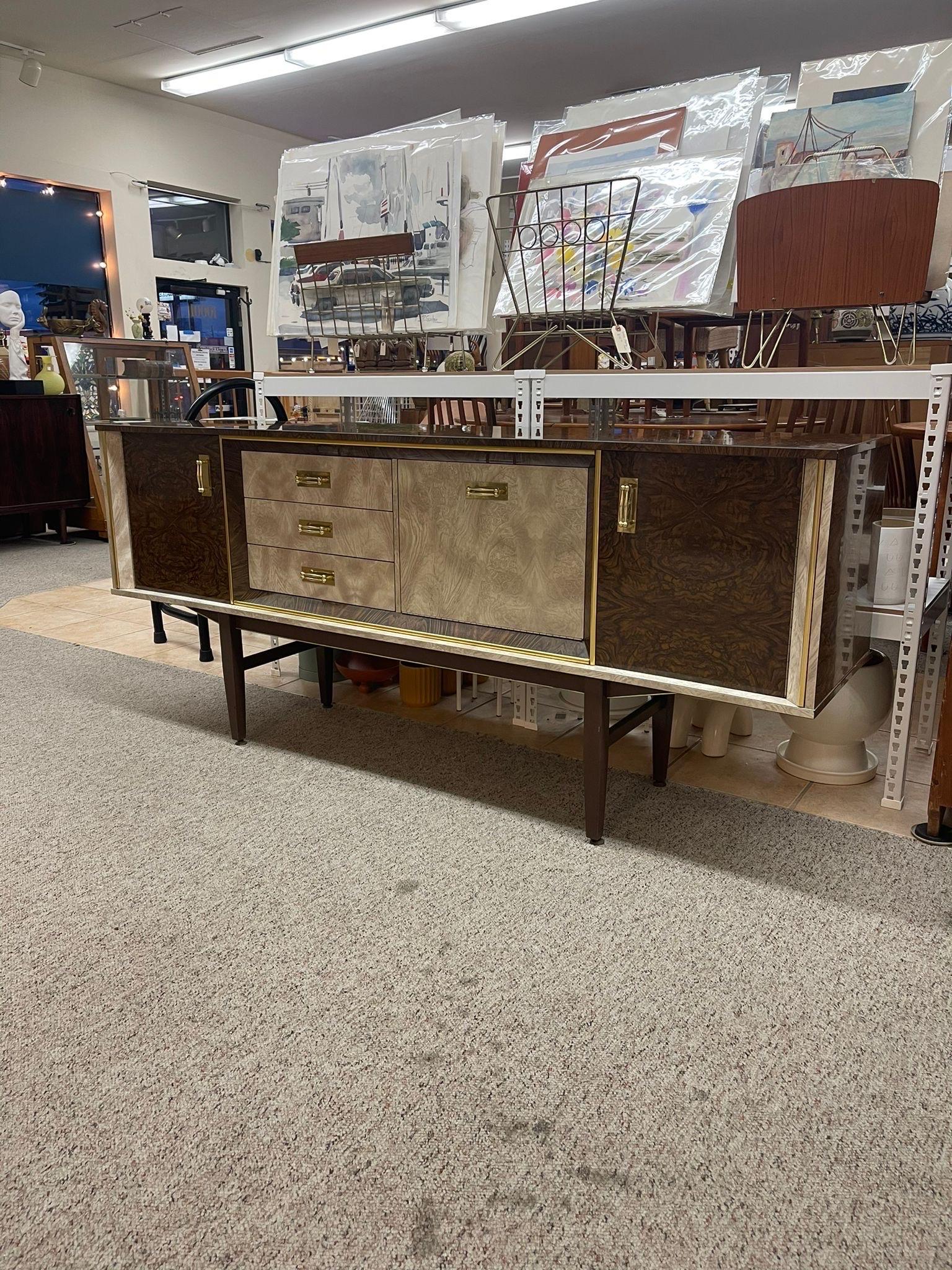 English Credenza with Unique Retro Design. Center Beige Section Features Three Drawers , Drop Front Cabinet. Outer Section Features Cabinet. Could be Used as a Bar Sideboard. Circa 1950s/1960s. Vintage Condition Consistent with Age as