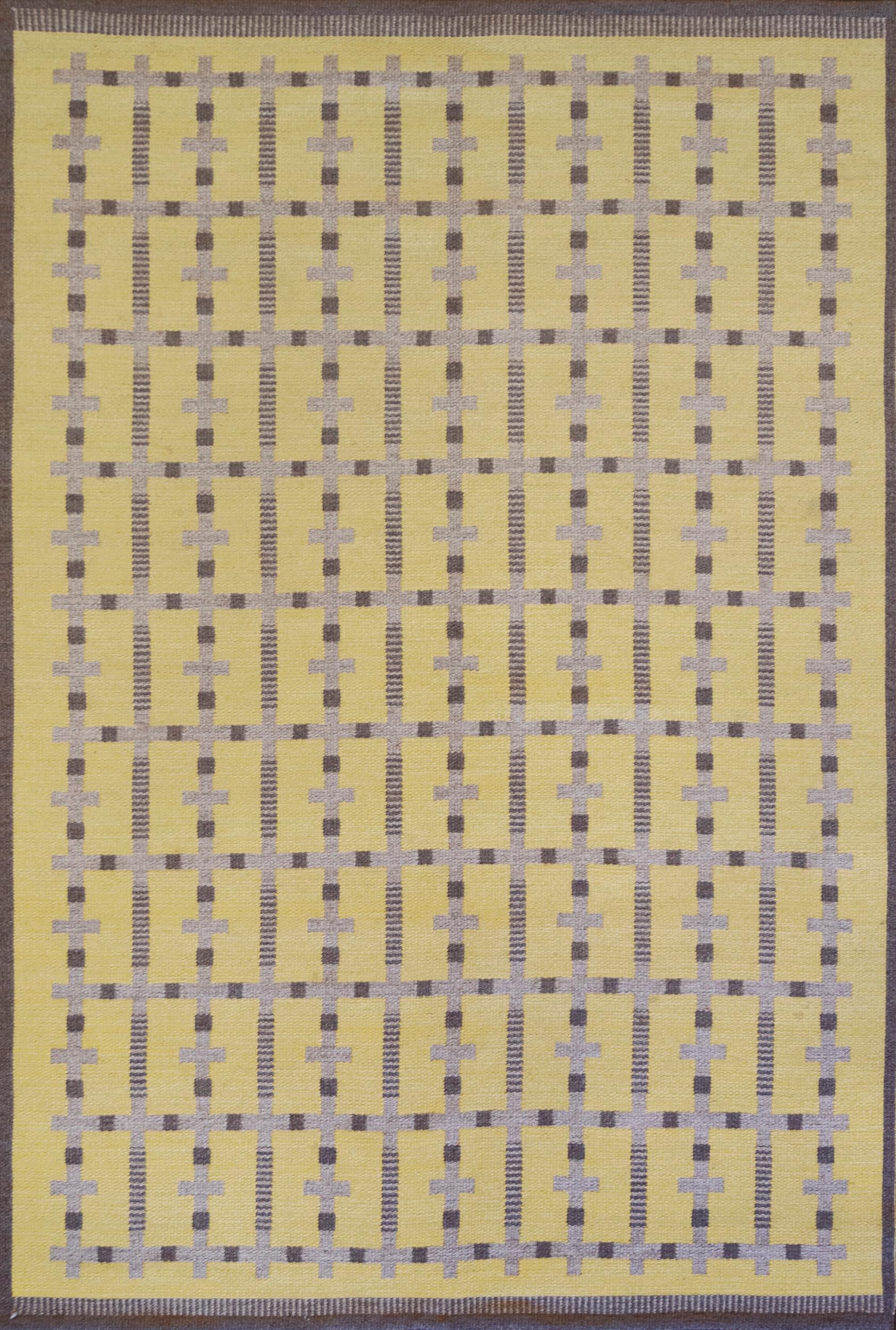 This handwoven vintage Swedish flat-weave rug is double-sided, either side can be displayed to match your decor. One side has a brown overall field with a darker brown and yellow cruciform lattice in a yellow border. The alternate side has a yellow