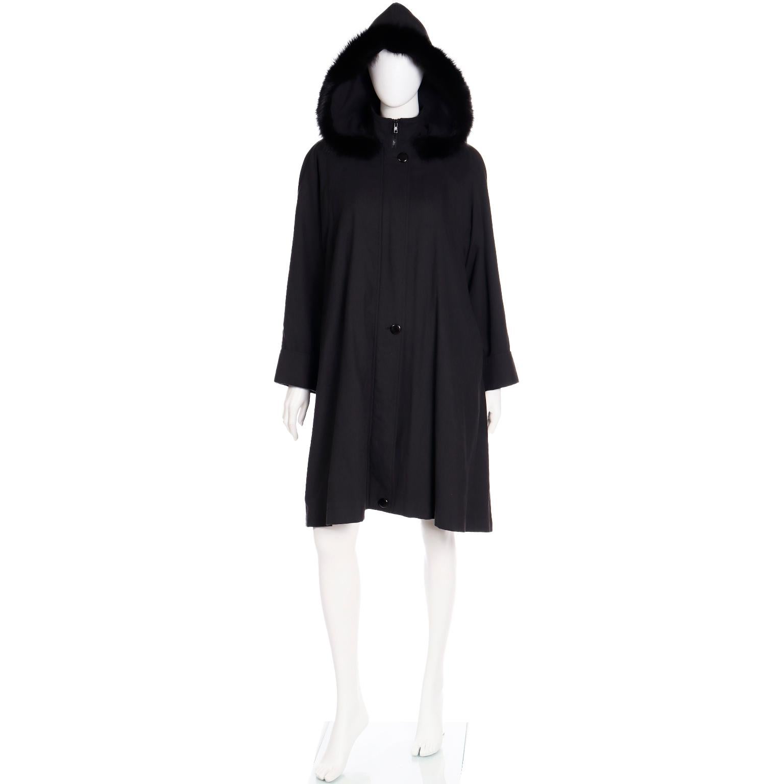 This gorgeous Revillon Boutique vintage coat is in a soft black all weather fabric and it has luxurious fox fur trim and fur lining. We love the removable hood and the fact that the fur can be removed from the hood if you'd prefer! Revillon was the