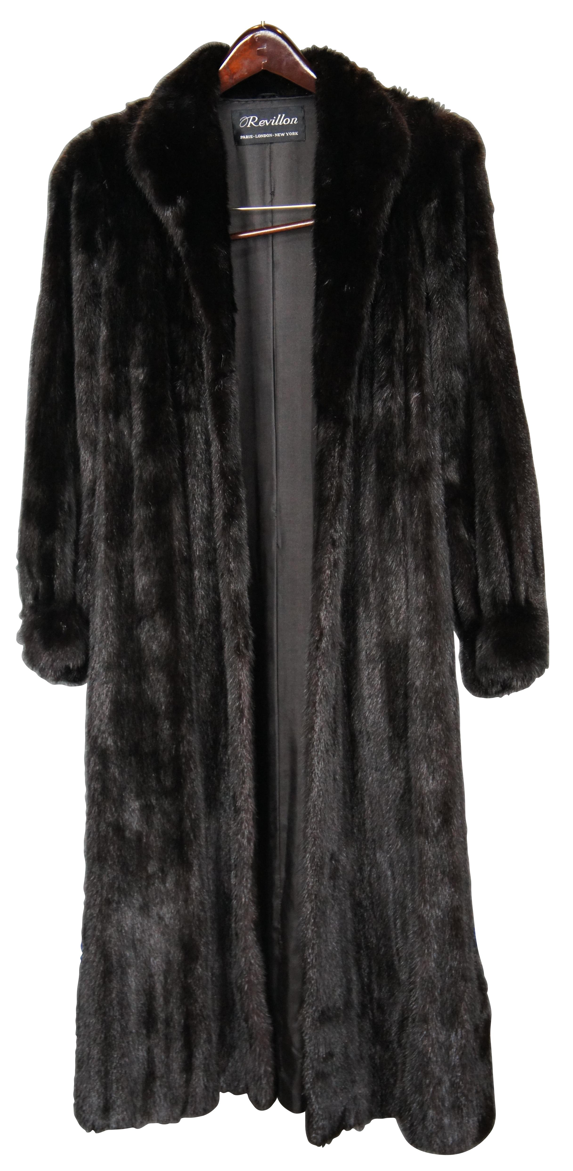 Vintage black mink coat by Revillon, full length with swivel hook and loop closure, two velvet lined side pockets, and decorative marbled buttons at the cuffs. Lining personalized with the initials BZS. Owner was 5'3