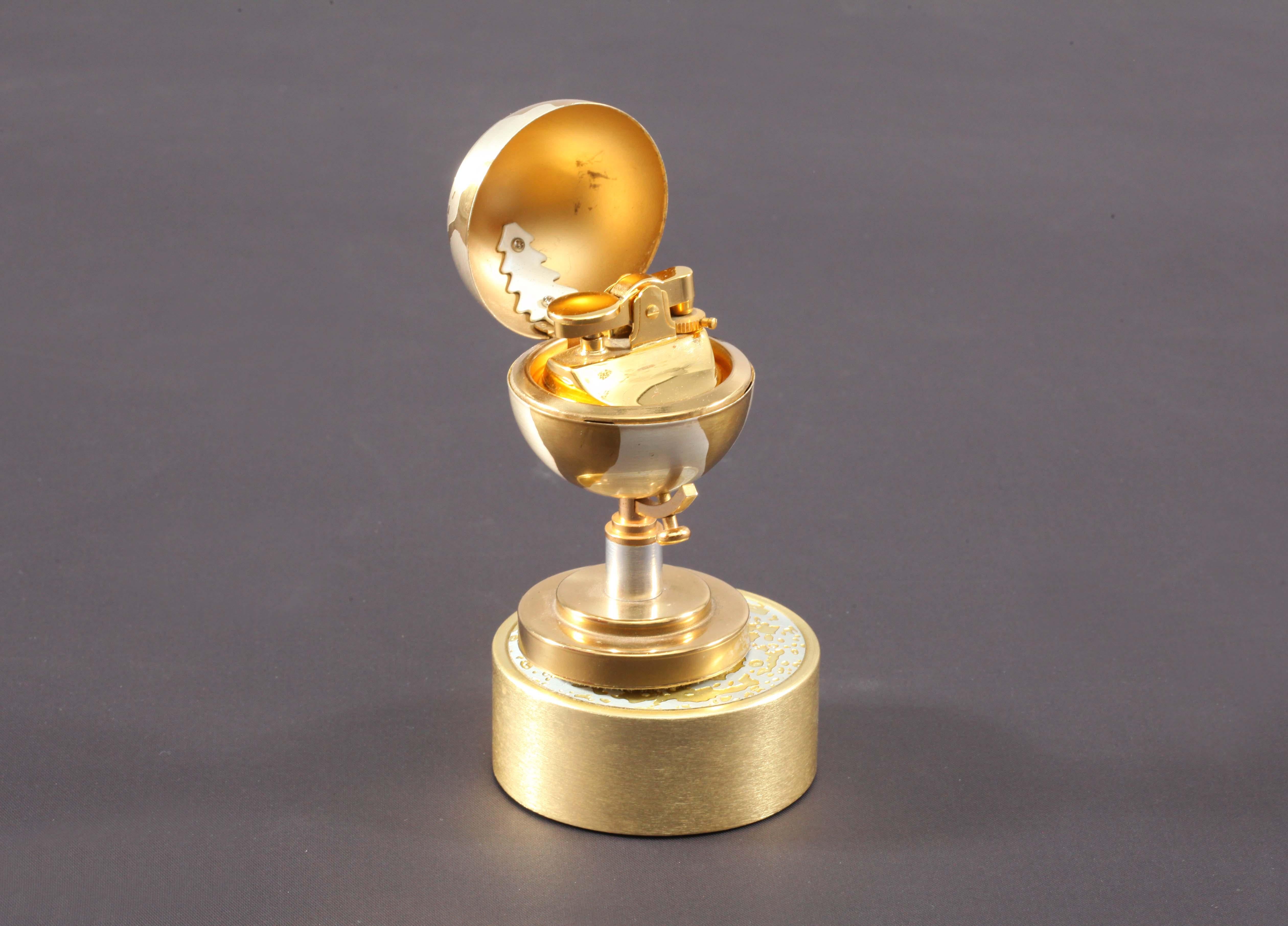Vintage gold colored metal Colibri table lighter in the form of a World Globe on a stand. The item is music box & the globe revolves as music played. Dates from circa 1950s. The lighter look's in nice used condition, spark wheel works well.