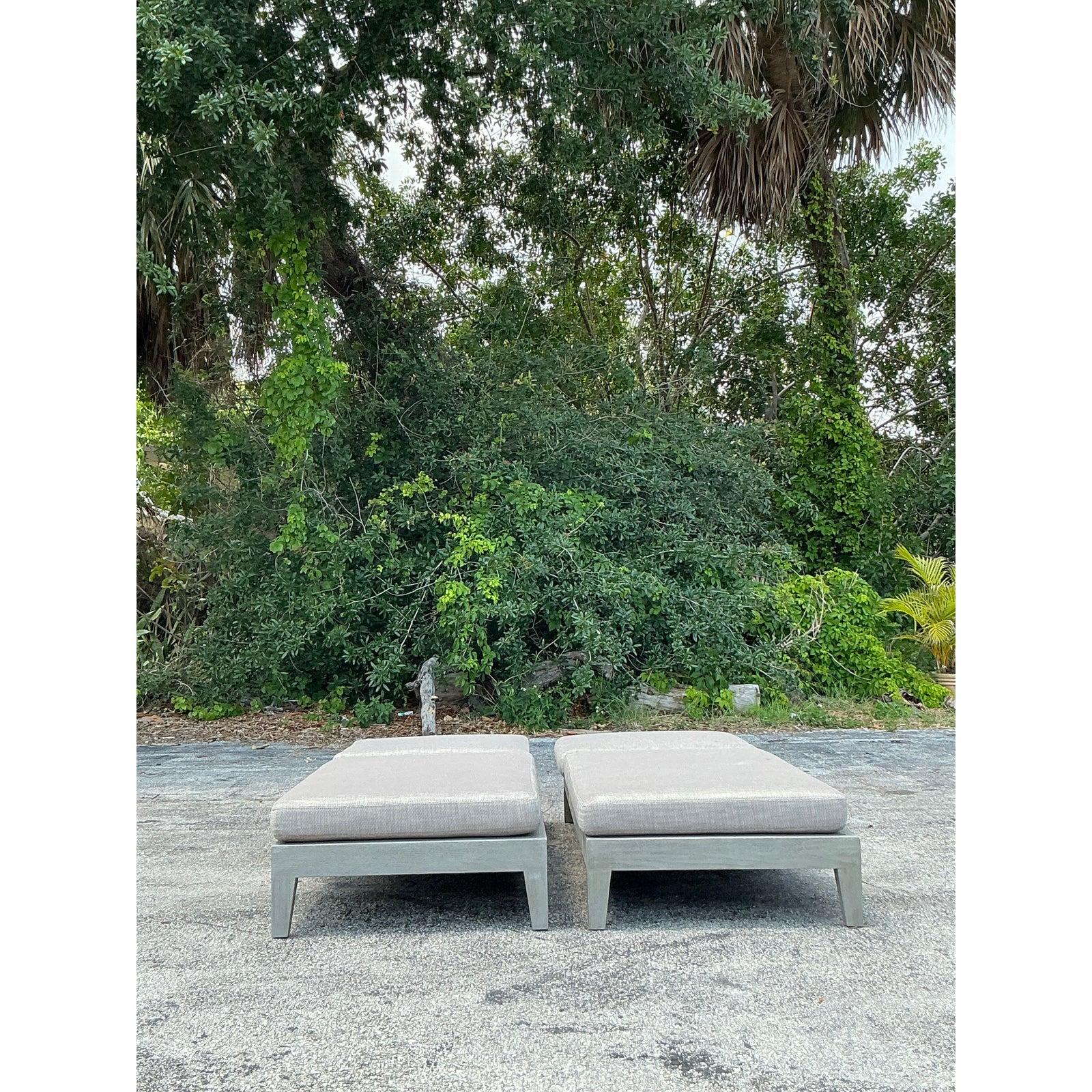 Bring resort-style sophistication to your outdoor oasis with this exceptional pair of “Balmain” After RH chaise lounges, meticulously crafted from solid teak in a weathered grey finish. Their minimalist, low-slung silhouettes and angular lines echo