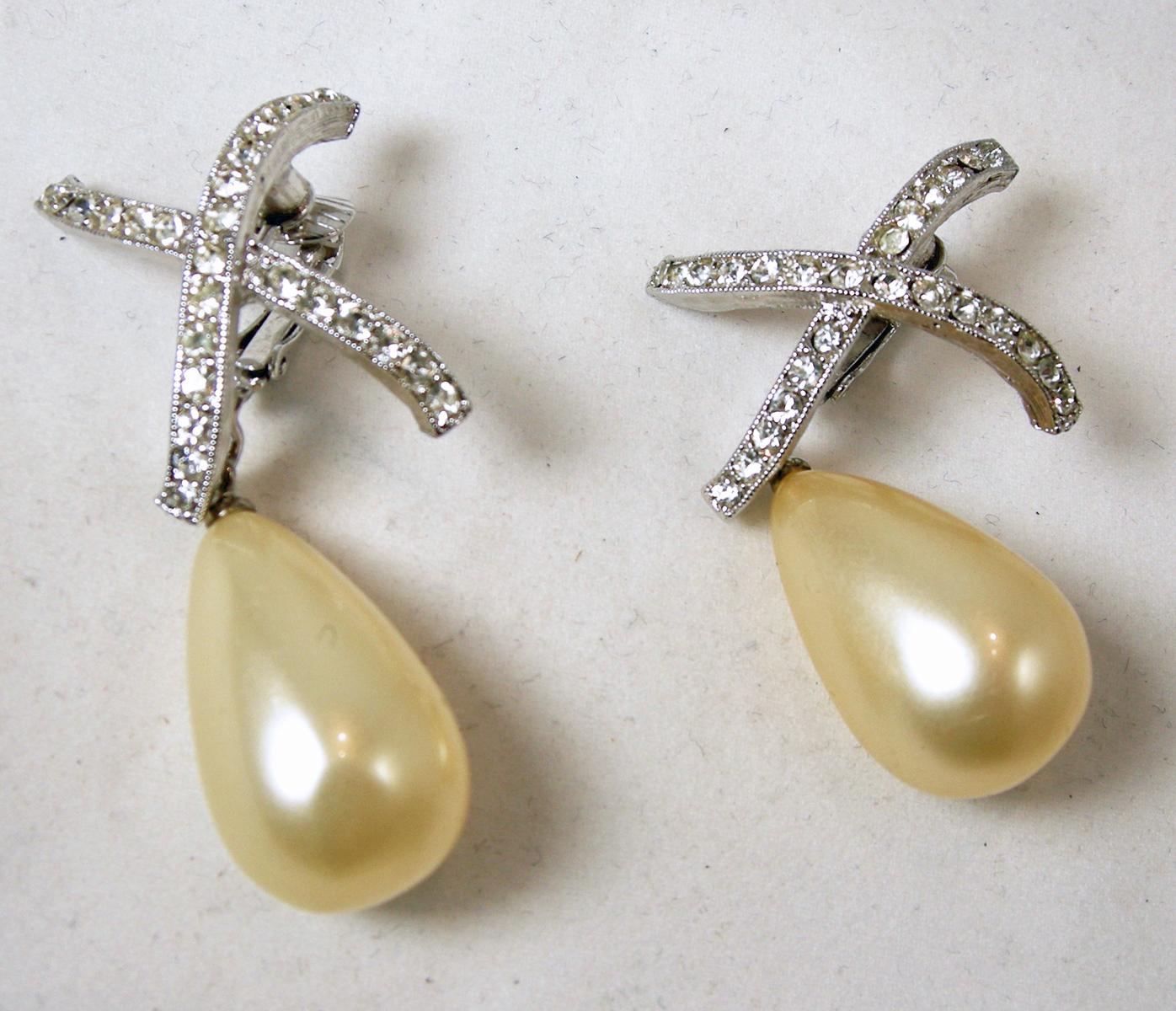 These vintage earrings are from the 1980s and perfect for any occasion.  The top has a rhinestone “X” and a large tear drop faux pearl.  They measure 2” x 1 and in excellent condition. 