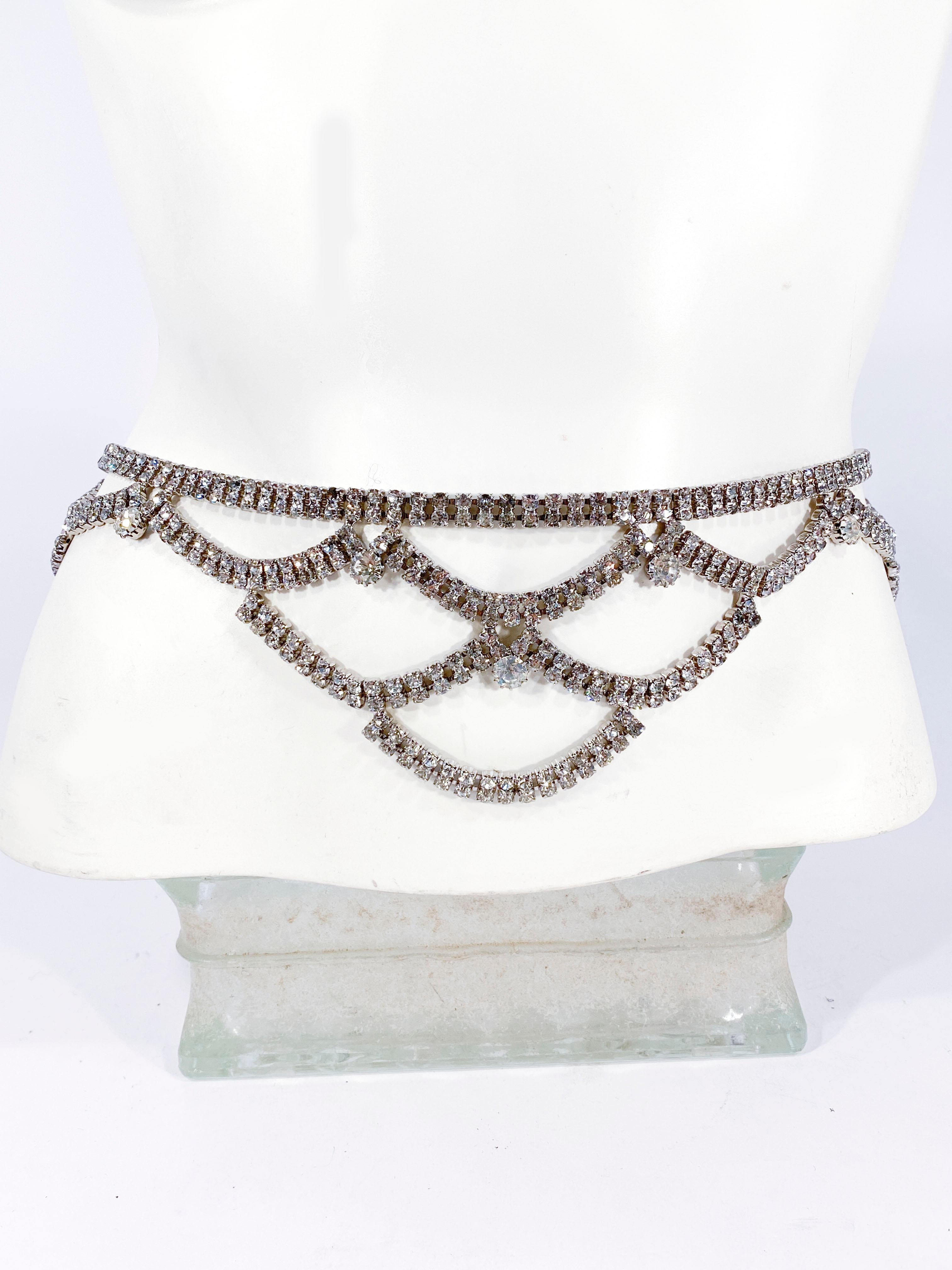 Vintage Rhinestone belt with tiered strands. This belt can be worn both on the waist and at the hip. The closure is a hook and adjustable stopper.