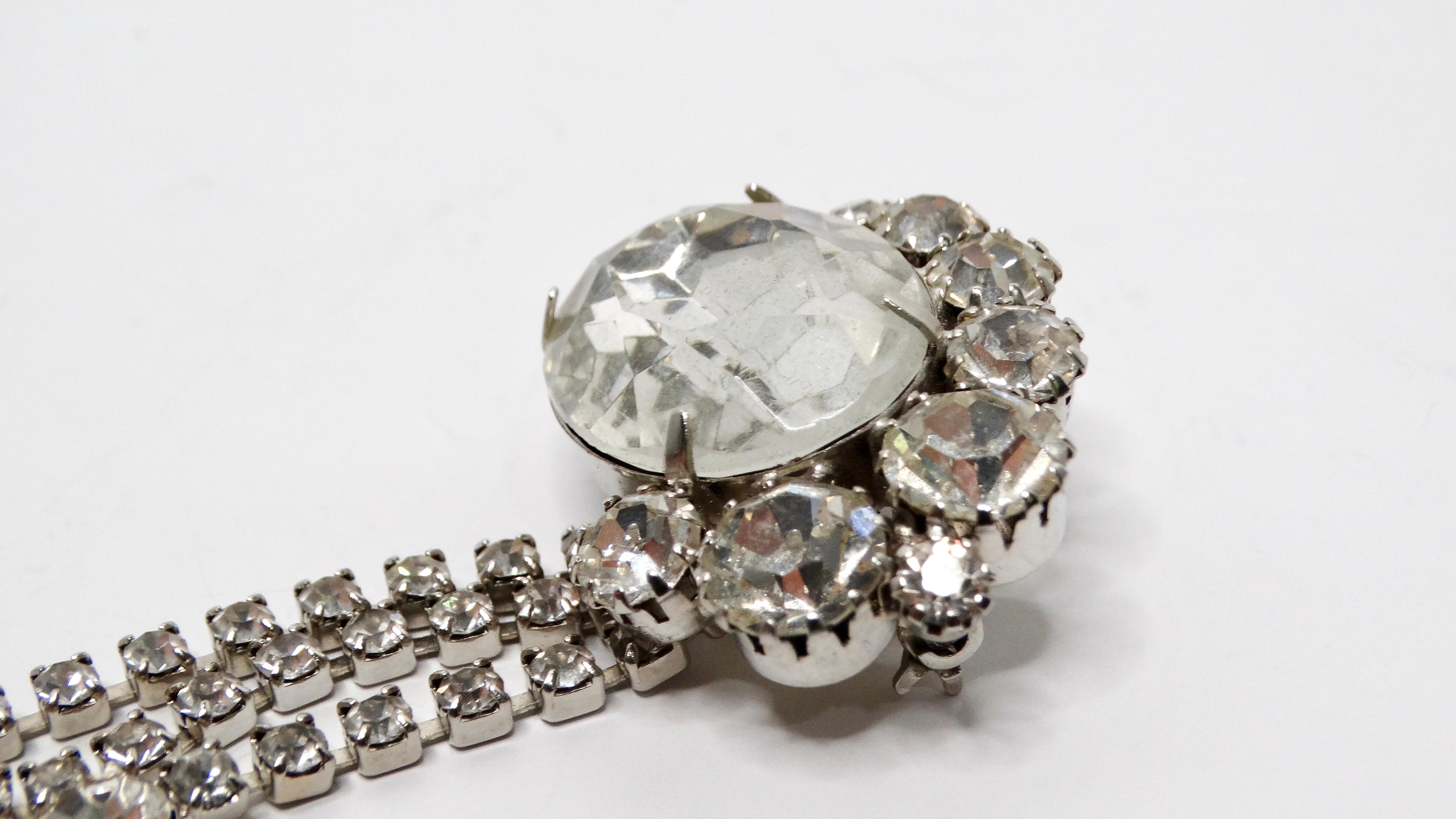 This exquisite Vintage Rhinestone Dangle Sterling Silver Plated Brooch is a stunning accessory that captures the elegance of bygone eras. Crafted with intricate detail, this brooch features shimmering rhinestones that catch the light beautifully,
