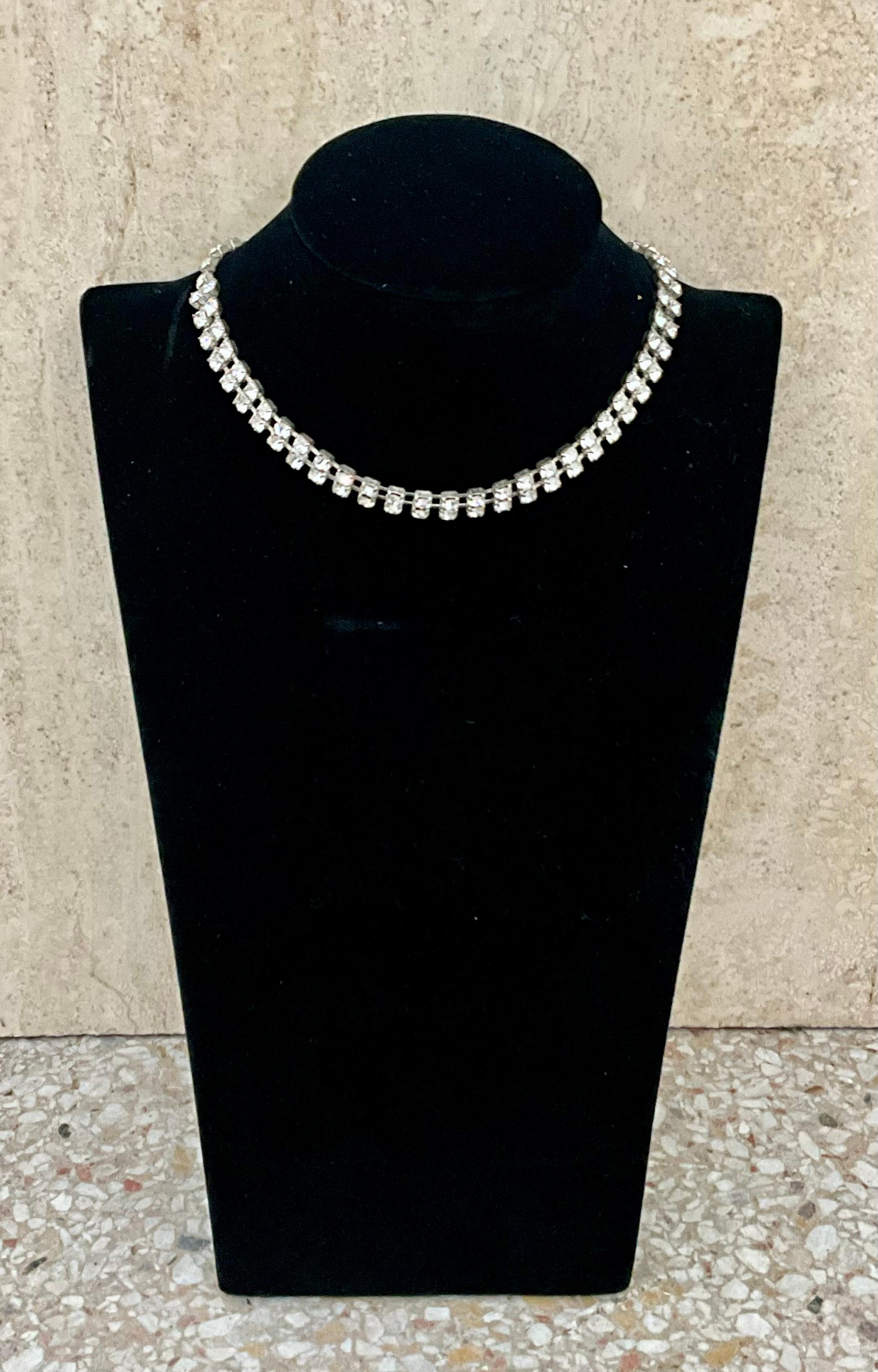This Vintage Rhinestone Double Row Tennis Necklace is a stunning and sophisticated piece of jewelry that combines the brilliance of rhinestones with a classic design.

The necklace is adorned with rhinestones, which are glass crystals designed to