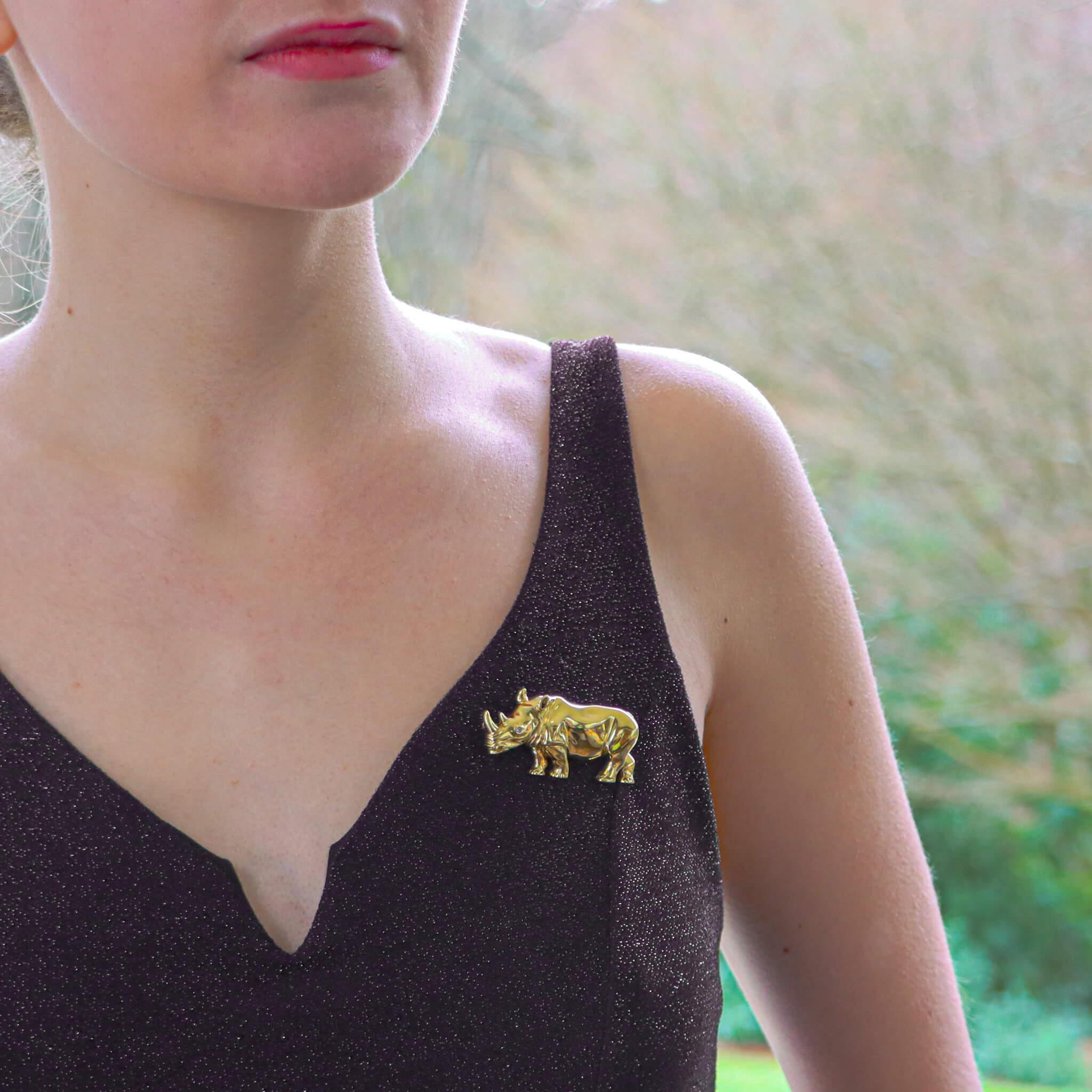  A beautiful vintage Rhino brooch set in 18k yellow gold.

The brooch depicts a standing side view of rhino which is set with a singular round brilliant cut diamond eye. The rhino's skin has been beautifully hand crafted in 18k yellow gold to give