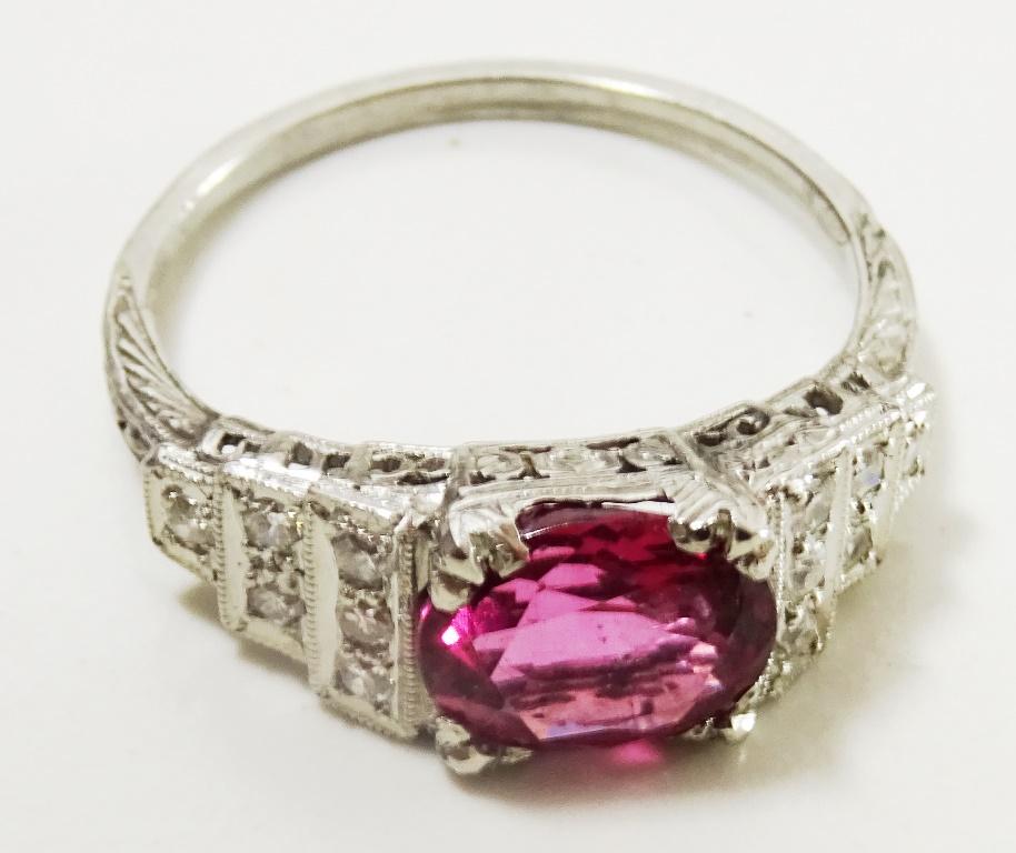 This original Platinum Ring ( fully marked ). 
Was sitting in some safe , at some point the main stone was removed and the ring laid unused for decades.
When it came to my hands we found this beautiful 7 x 9 mm oval Rhodolite Garnet of the highest