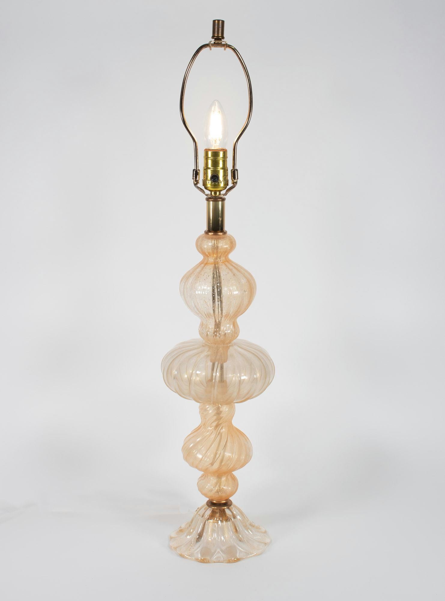 This Mid Century Murano glass table lamp is made in the style of Barovier & Toso, a renowned Murano glasshouse. The lamp was crafted from fluted blown glass sections stacked atop each other resulting in a multi-tier bulbous silhouette.

The