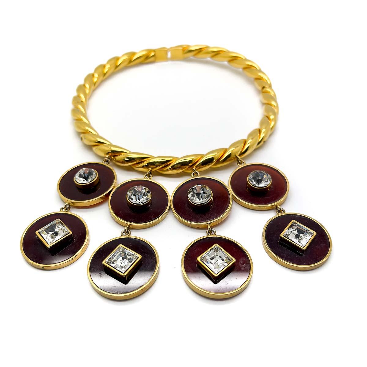An incredible Vintage Gold Tortoiseshell Disc Choker. A superb design featuring a lustrous, fixed twisted gold choker. The choker adorned with four lines of rich brown tortoiseshell resin discs, each set with a fancy cut crystal and cascading to