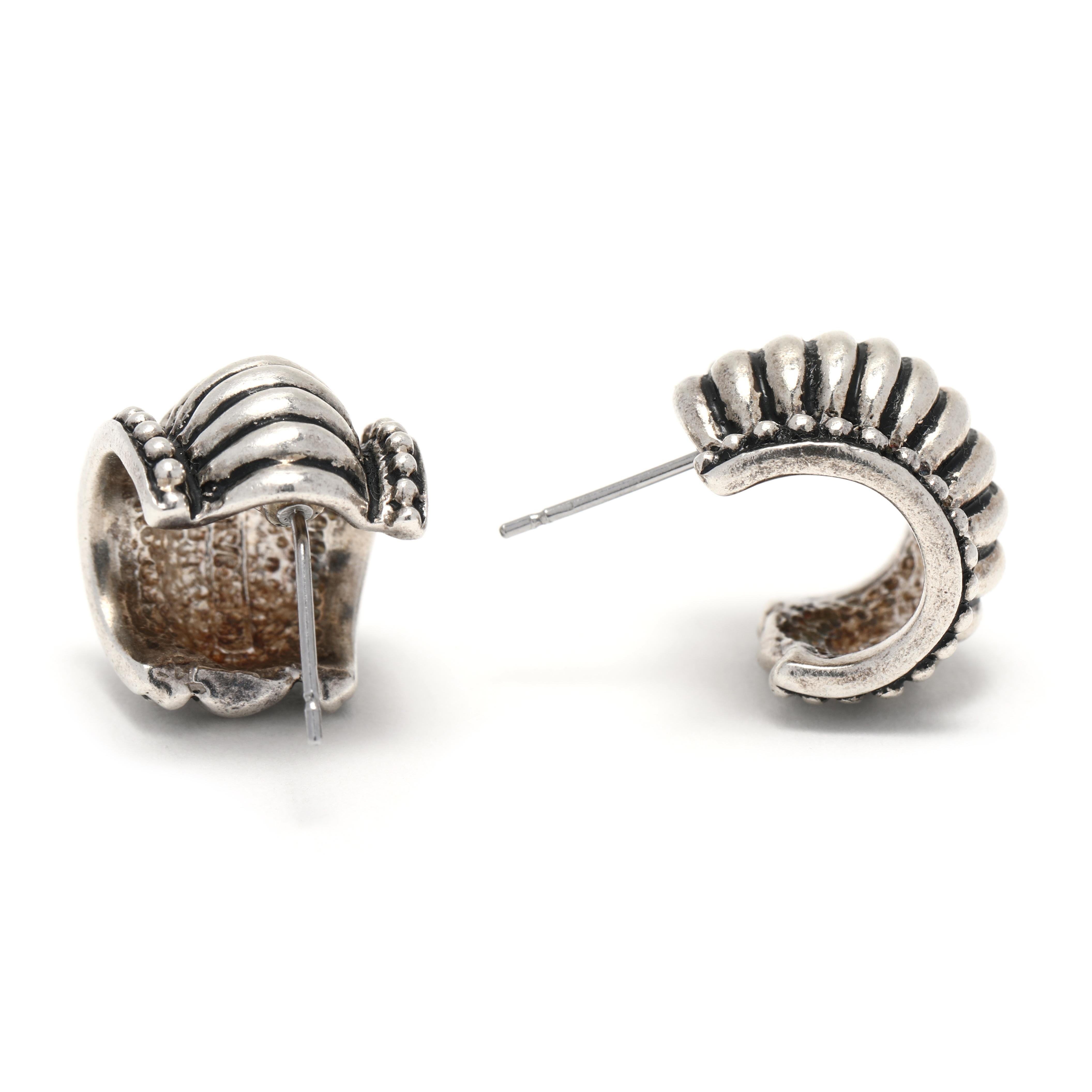 These stunning Vintage Ribbed Shrimp Huggie Hoop Earrings are the perfect way to make a statement! Crafted from sterling silver, they measure 1/2 inch in length and feature wide silver hoops with a unique ribbed shrimp design. They are the perfect