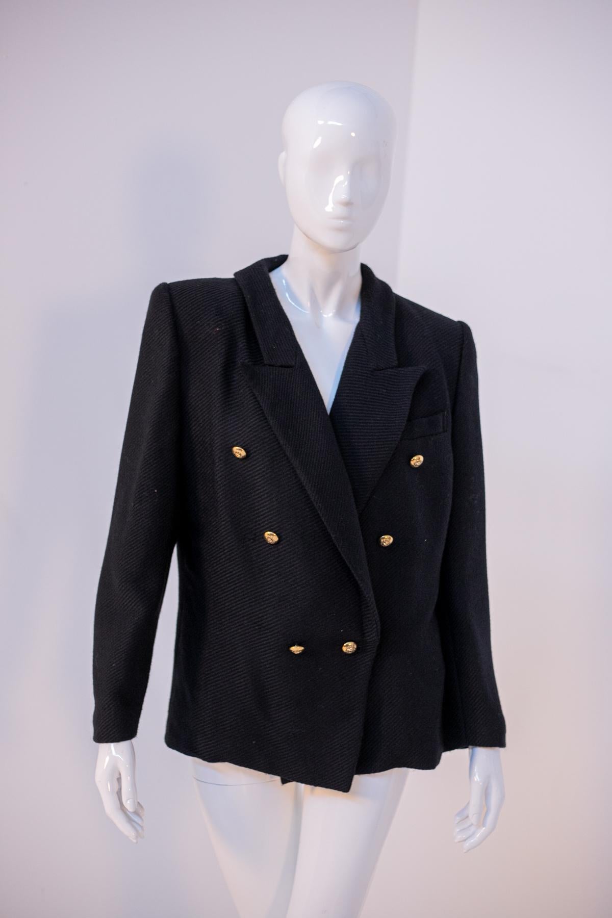Beautiful stylish wool blazer from the 1990s, made in Italy.
ORIGINAL LABEL.
The blazer is totally black ribbed wool and has long sleeves with soft cuffs.The cut of the jacket is double-breasted. 
The collar has a classic wide and deep list cut.