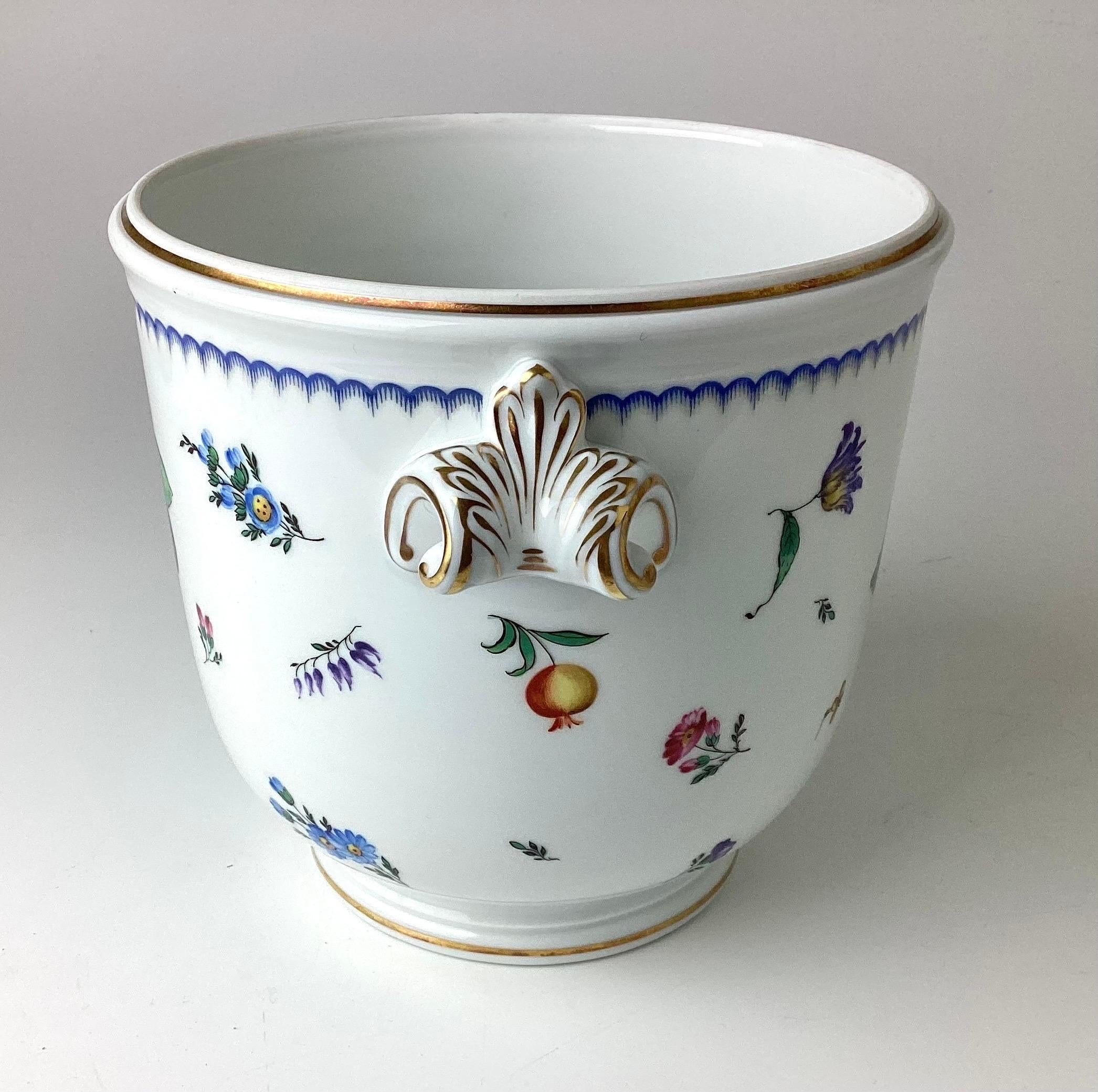 A fine bone china decorative and pretty piece by the re known Italian porcelain firm of Ginori. Hand-painted botanicals and 24-karat gilt trim highlight this piece. Impressive in size and could also be used for a centerpiece, ice bucket or a lovely