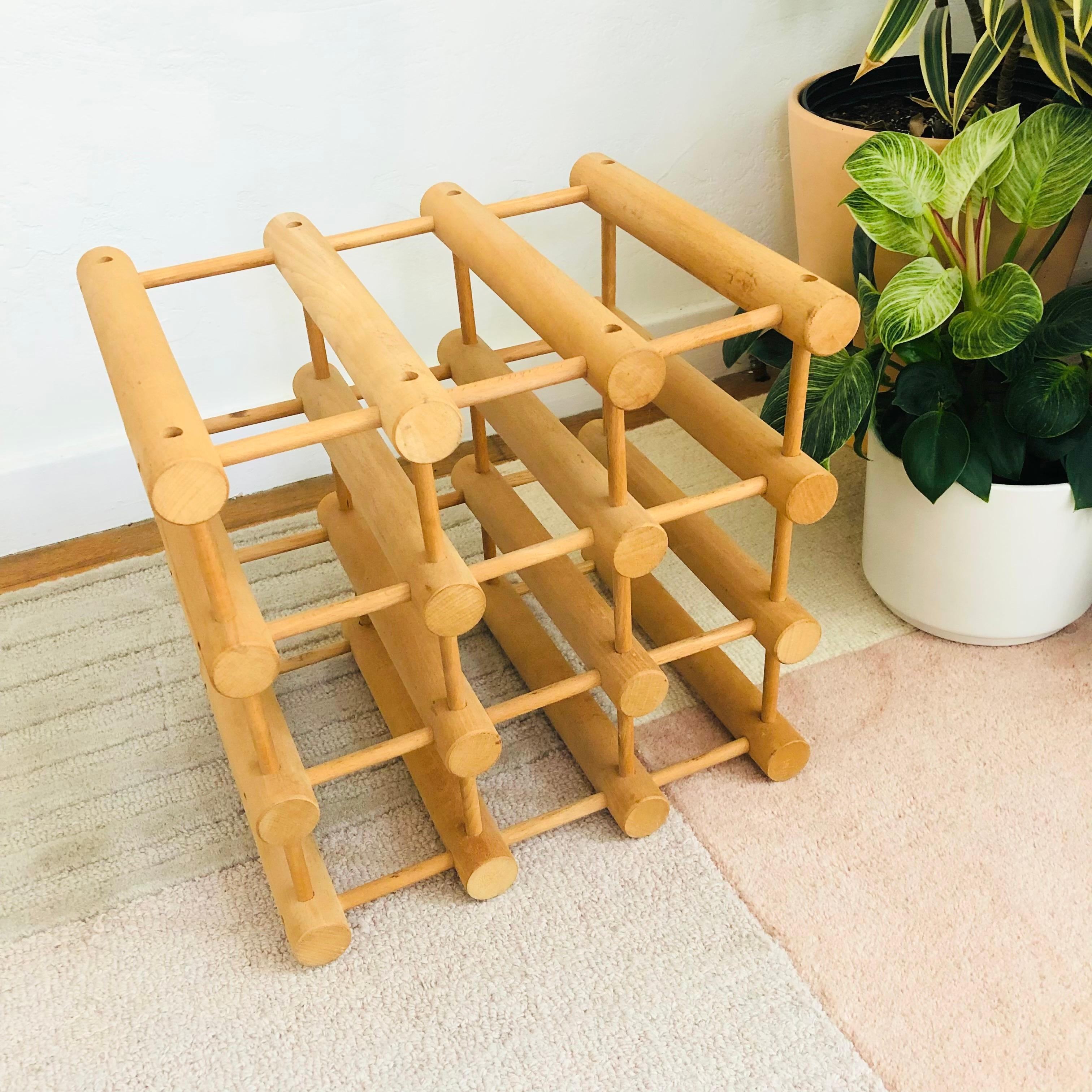 An original vintage wine rack designed by Richard Nissen from Langaa, Denmark. Beautiful minimalist wood peg design made of unfinished beechwood. Can hold 12 bottles. Stamped at the end of one peg 