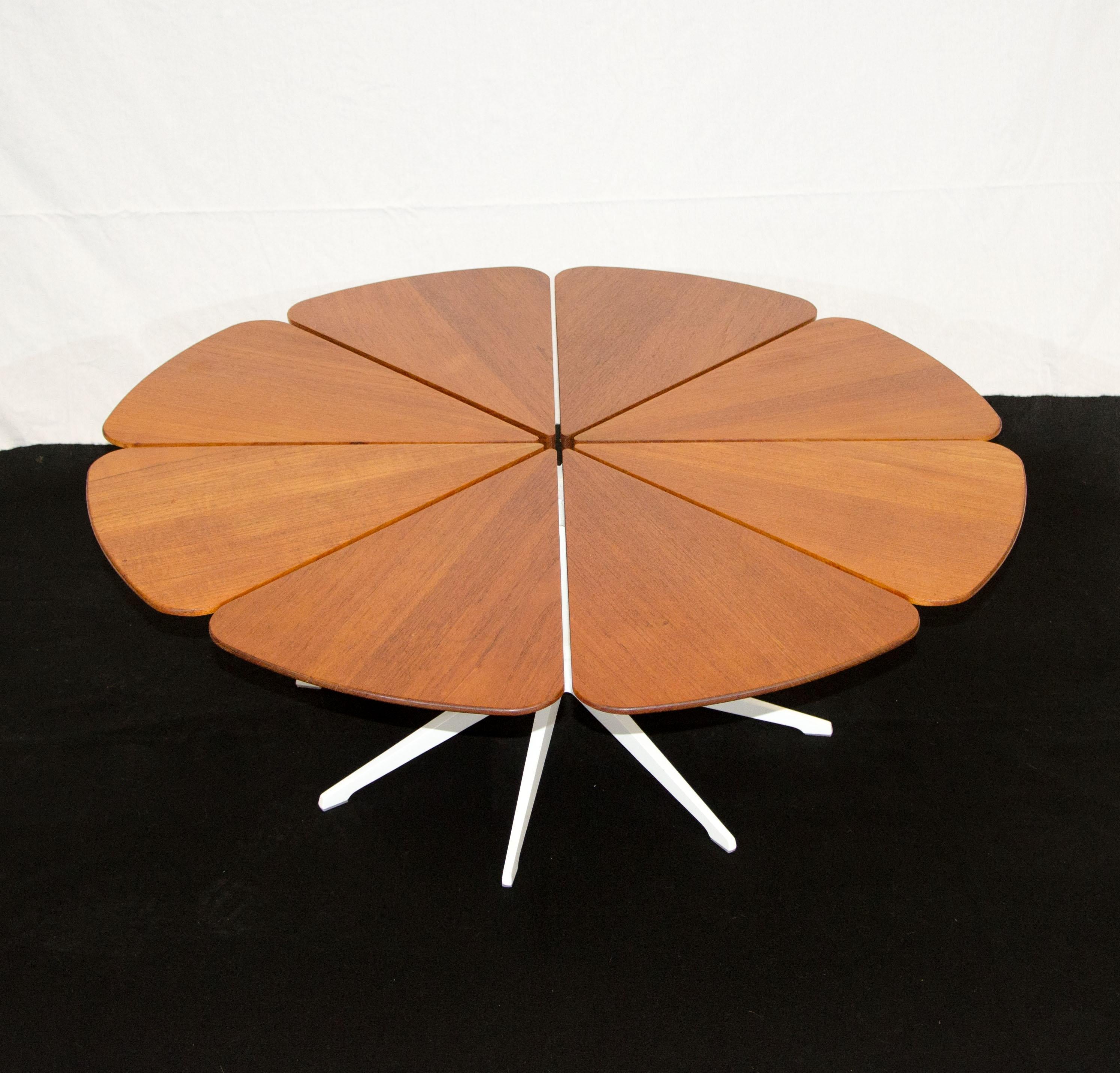 Iconic petal table designed by Richard Schultz and manufactured by Knoll. The eight separate petal tops are solid vertical grain teak and are being supported by a powder-coated cast aluminum framework and powder-coated stainless steel stem. The