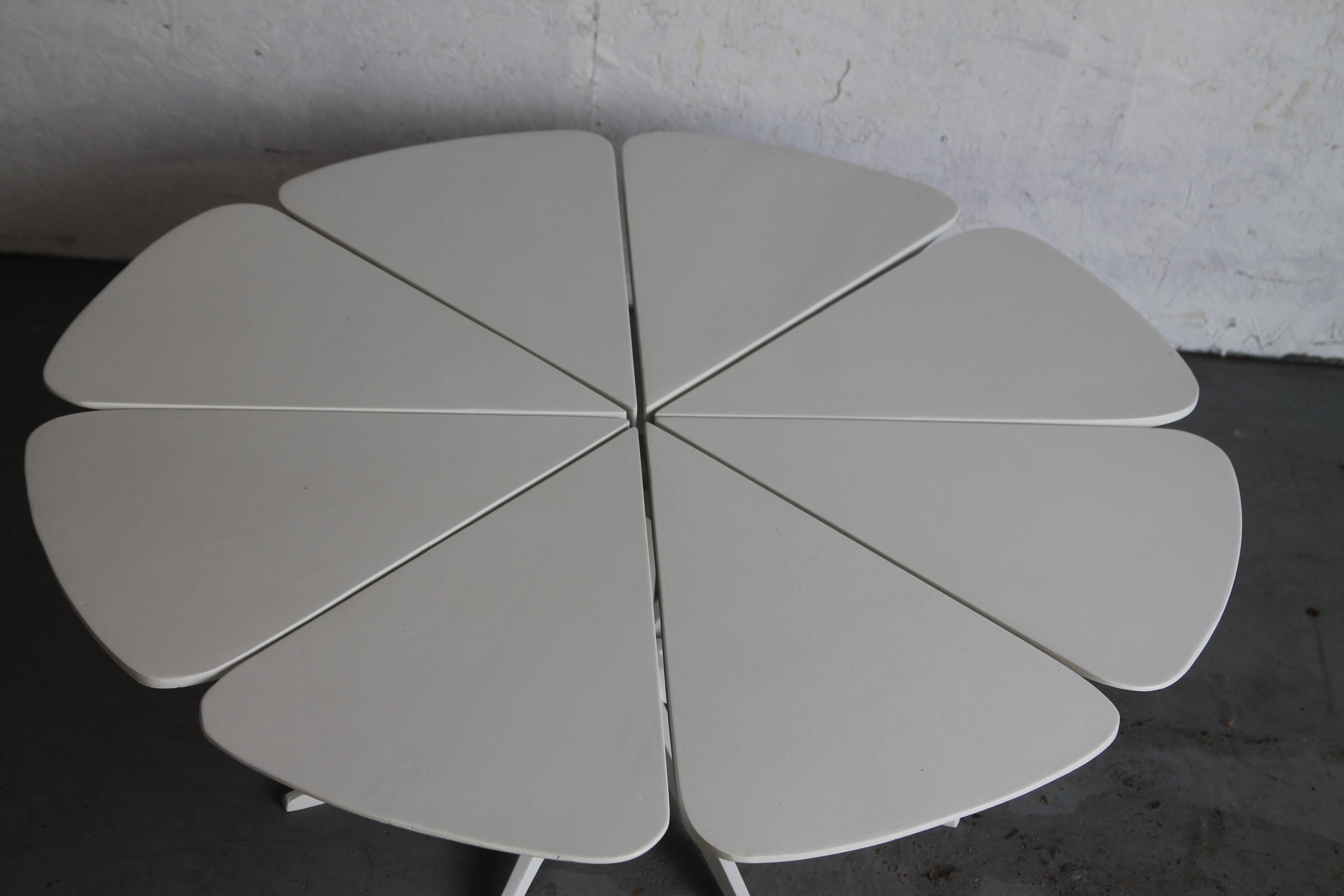 Iconic petal table designed by Richard Schullz for Knoll from 1960-1974. It is constructed with 8 redwood petals that are painted white. These sit on a 8 elongated metal feet. This was purchased from the original owners who got it in the 1960s. 