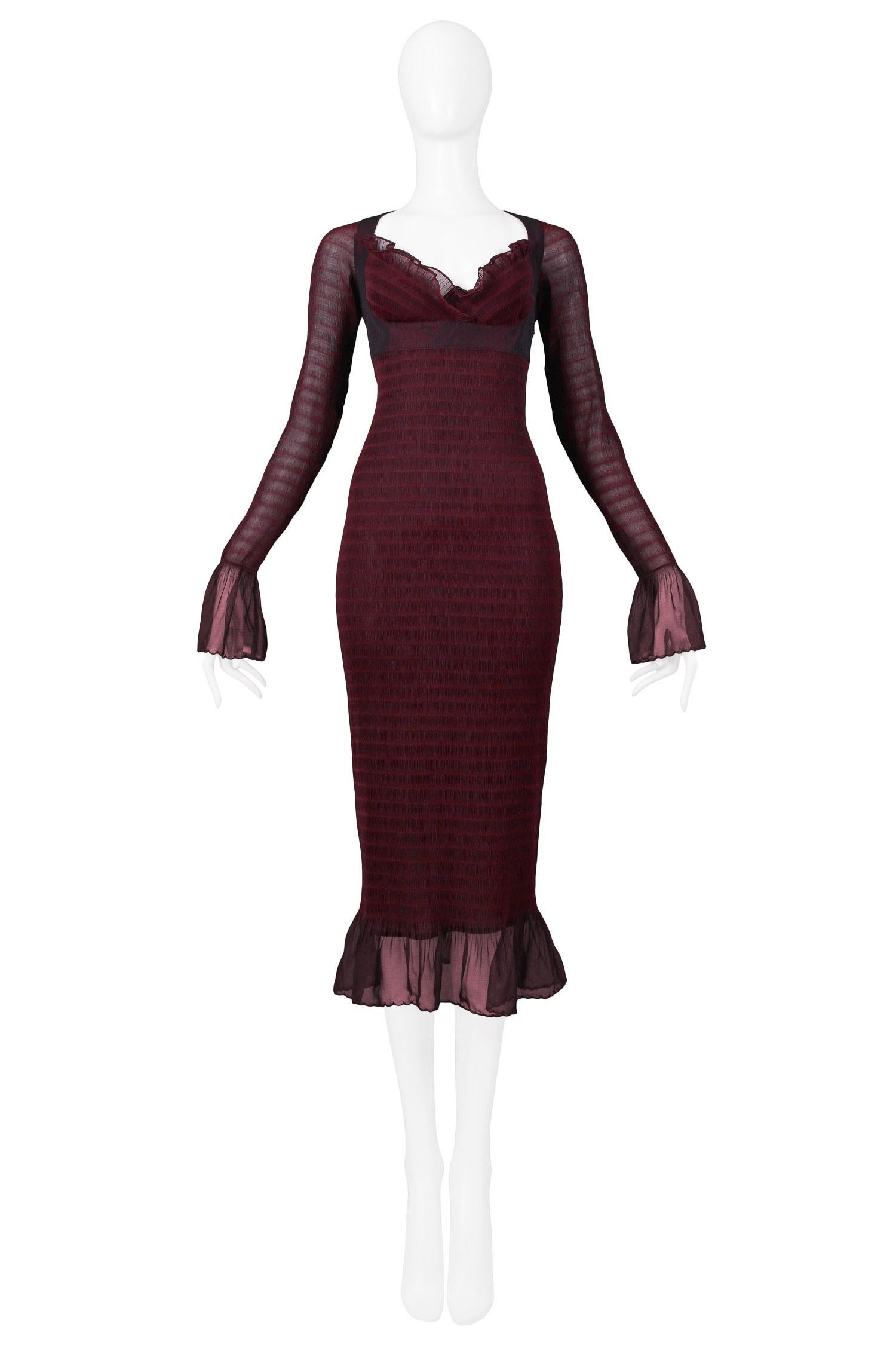 Vintage Rifat Ozbek burgundy stripe mesh 3/4 length dress featuring ruffles at bust, cuffs, and hem, attached bra bodice, and novelty stretch striped mesh fabric. 

Excellent Vintage Condition.

Size 44