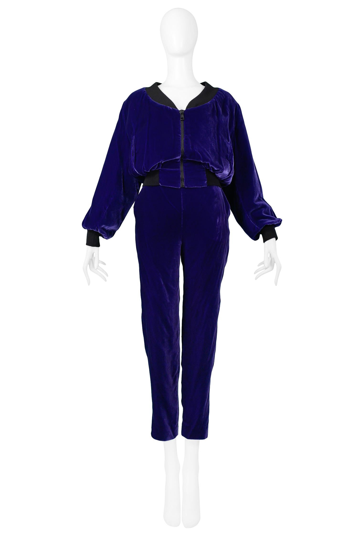 Vintage Rifat Ozbek royal purple velvet bomber jacket and pants ensemble. Bomber jacket features exposed neckline, center front zipper, contrasting black collar, waistband, and cuffs, side pockets, and metallic quilted gold lining. Pants feature