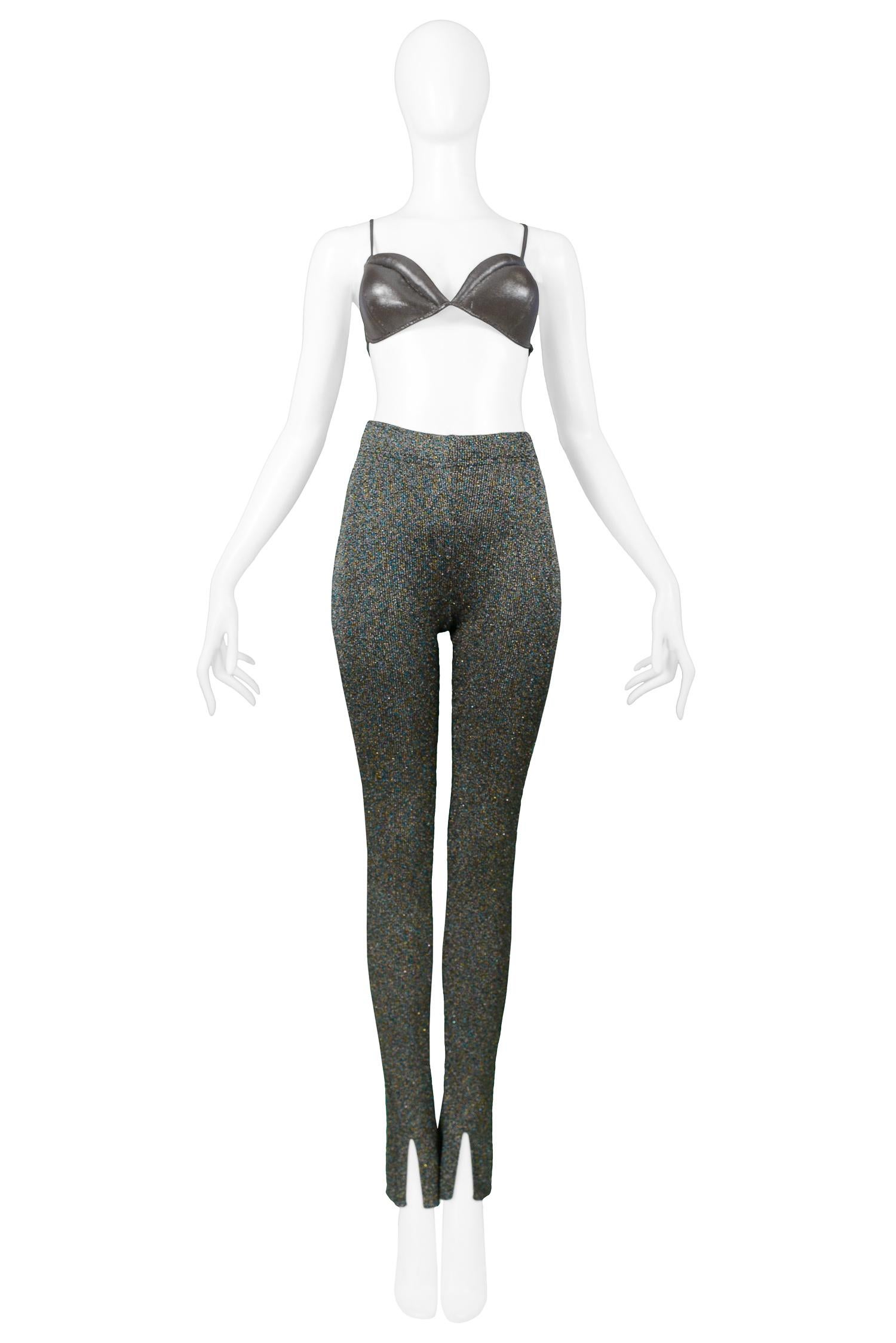 Vintage Rifat Ozbek silver metallic bra, leggings, and see-through blouse ensemble. The bra features metallic pewter molded / padded bra with elastic back for an easy fit. Leggings feature metallic pewter knit, high waist, and slightly flared cuff