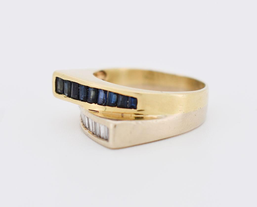 This original ring is designed in two distinct parts, creating an elegant effect of two rings in one. The yellow gold element (14 carat, 585 millièmes) is adorned with 9 sapphires totaling approximately 0.50 carat. The white gold element (14 carat,