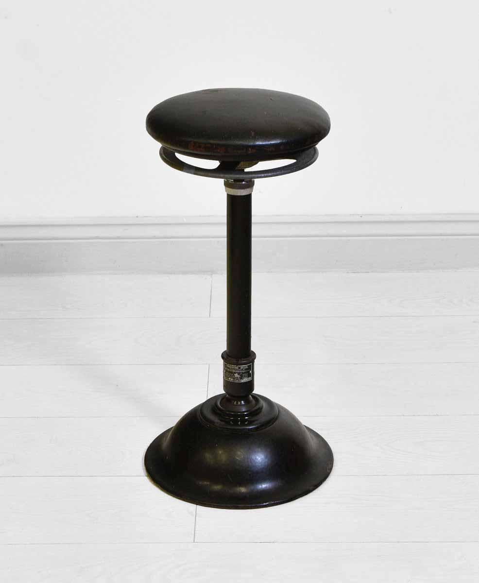 A vintage metal Ritter AG Durlach/Baden metal stool with black leather seating. Made in Germany. Circa 1930's.

Free UK shipping.

The stool would have been used by the dental profession. It is in full working order, with a swivel seat which has