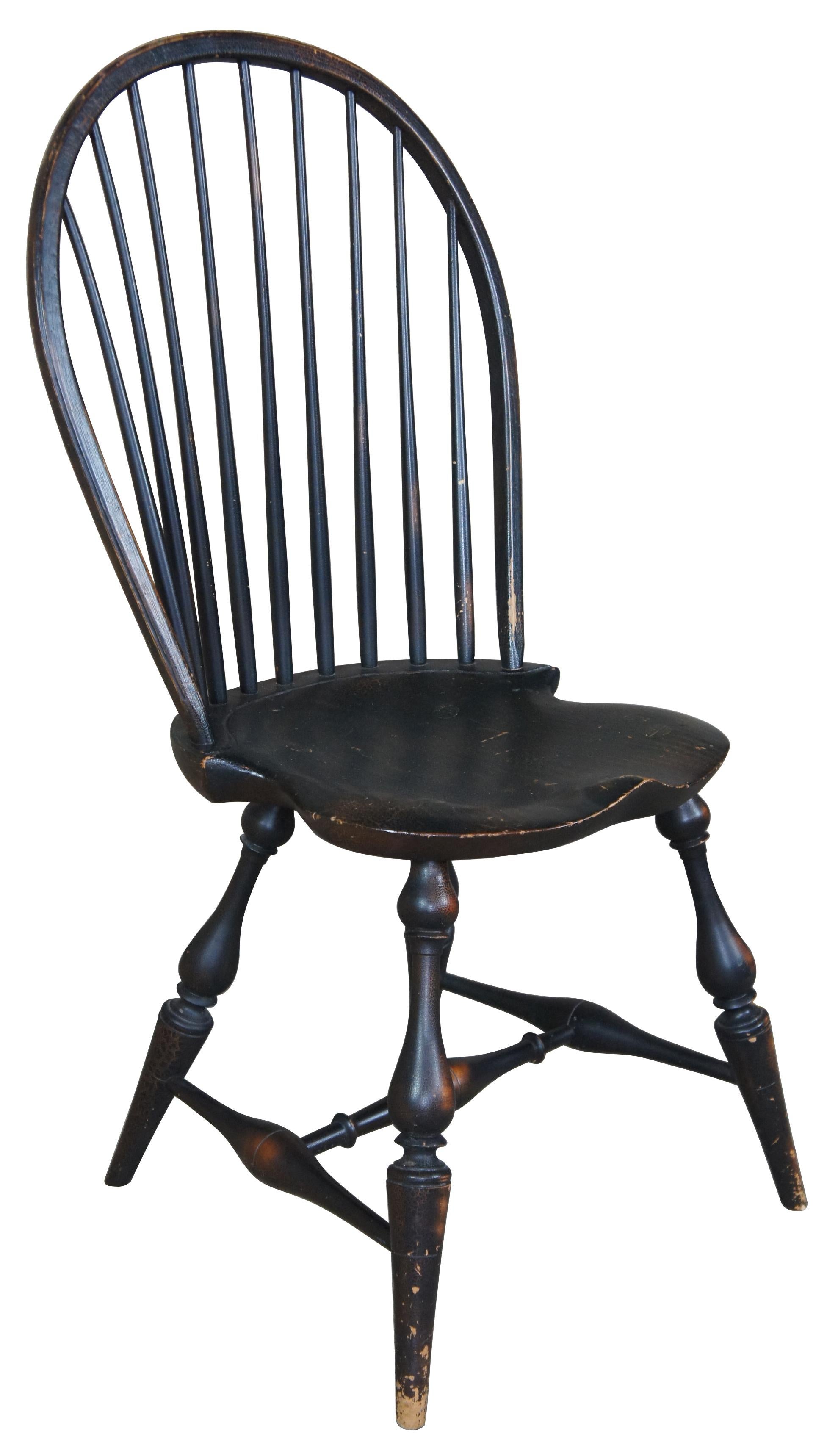 Late 20th century bow back Windsor chair by River bend Chair Co. Features a black crackle finish with vase shaped legs.
    