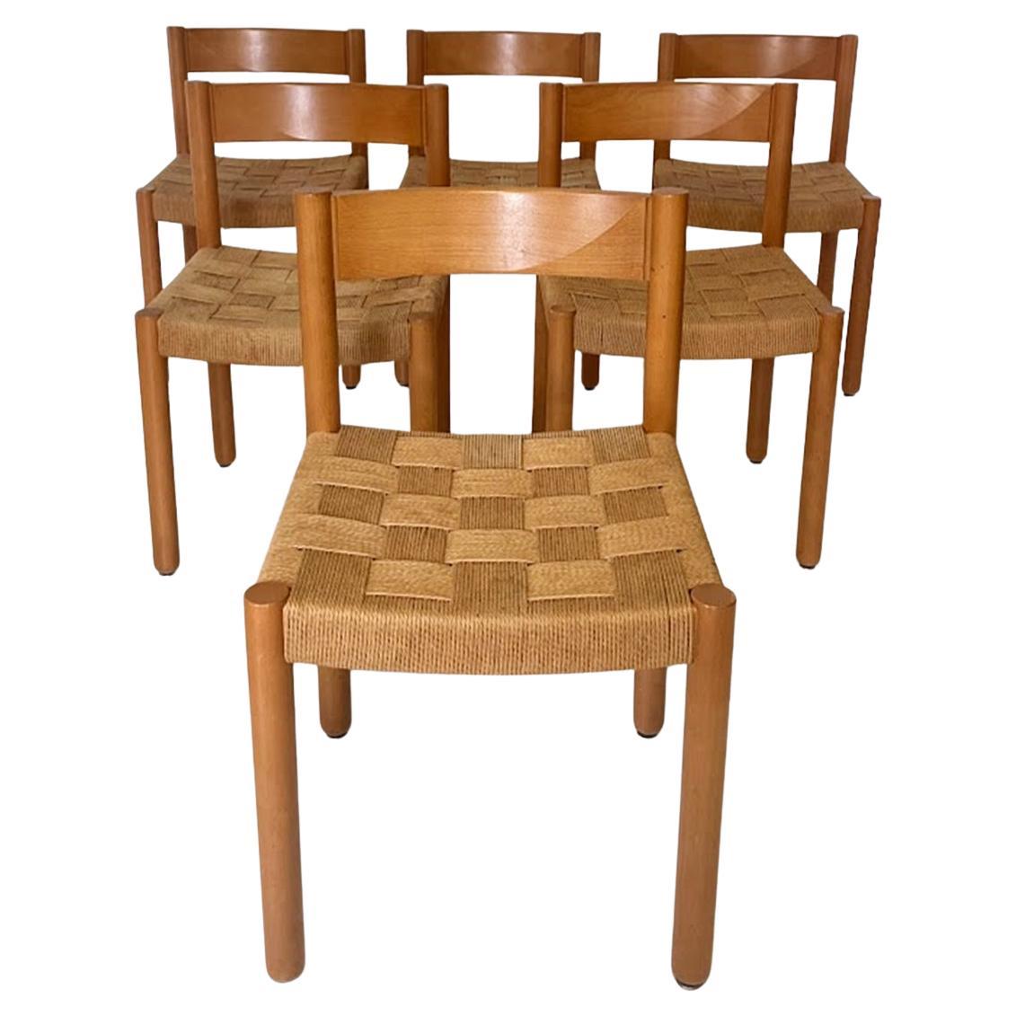 Indulge in mid-century modern elegance with this  chairs, designed by Robert Haussmann in 1963. Crafted from solid oakwood and featuring seats made of braided cord, these chairs showcase minimalist aesthetics with a touch of postmodern flair.