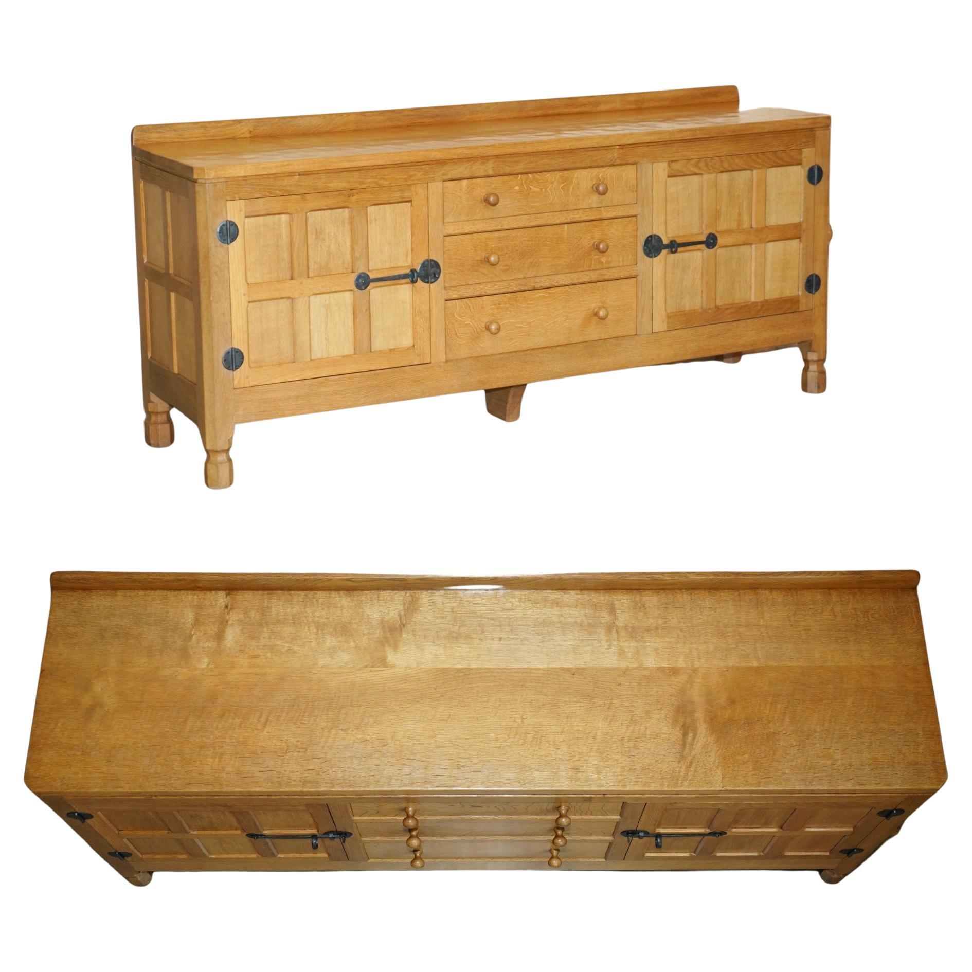 Royal House Antiques

Royal House Antiques is delighted to offer for sale this stunning Vintage Robert Mouseman Thompson hand made in England sideboard along with newspaper cutting that was part of a suite

Please note the delivery fee listed is