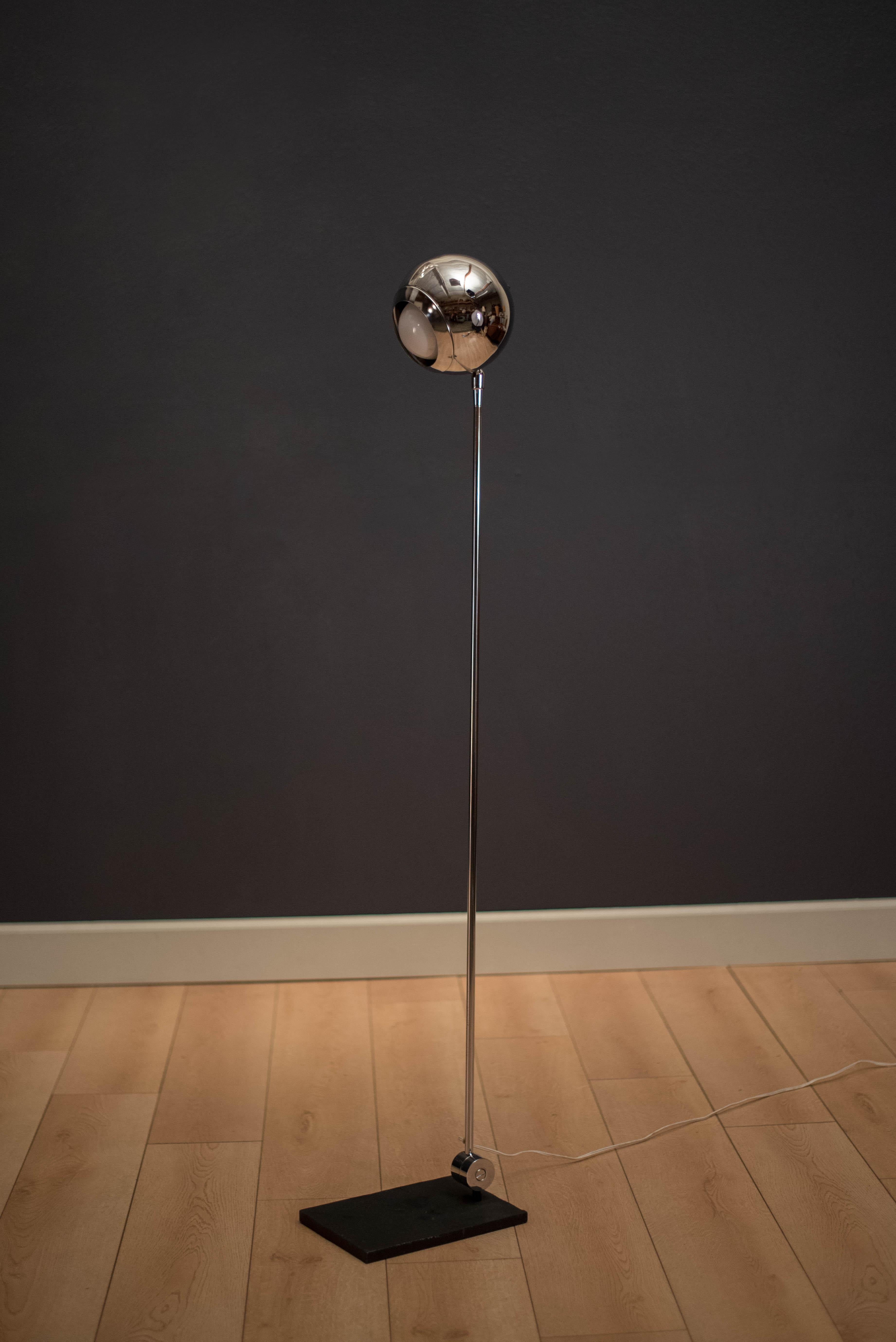 Mid-Century Modern floor lamp designed by Robert Sonneman in polished chrome. This piece can be adjusted from the base and head tilts up and down.
 