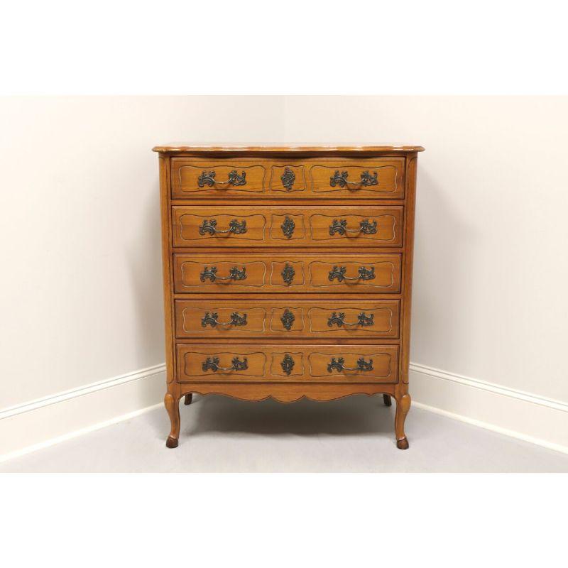 A French Provincial style chest by Robert W Irwin Co of Grand Rapids, Michigan, USA. Made in the early 20th century of solid walnut with brass hardware and faux keyhole escutcheons. Features five dovetail drawers, top drawer with built in jewelry