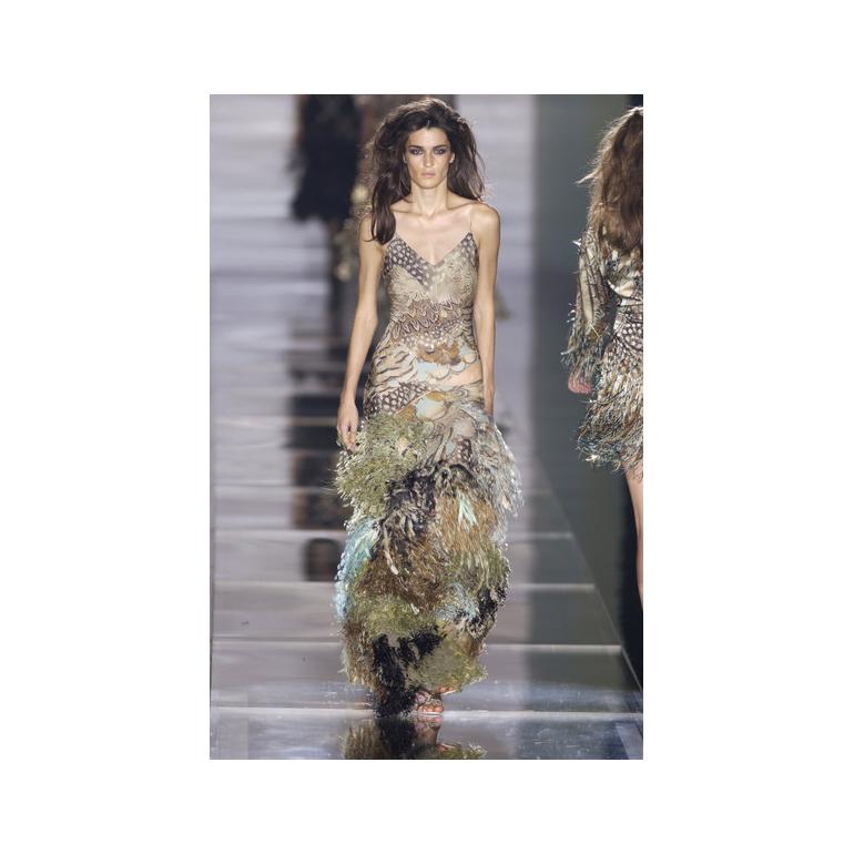 Resurrection Vintage is excited to present a vintage Roberto Cavalli multicolor feather print silk halterneck evening gown featuring bead and feather detailing at neck ties, keyhole accent at chest, dramatic fishtail ruffle hem with cutouts and an