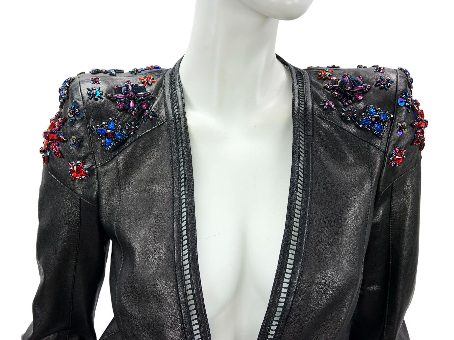 A striking and rare piece from Roberto Cavalli, this sculpted black leather jacket is an exquisite example of the brand’s signature blend of glamour and edge. Crafted in buttery soft leather, the jacket features a flattering slightly fitted