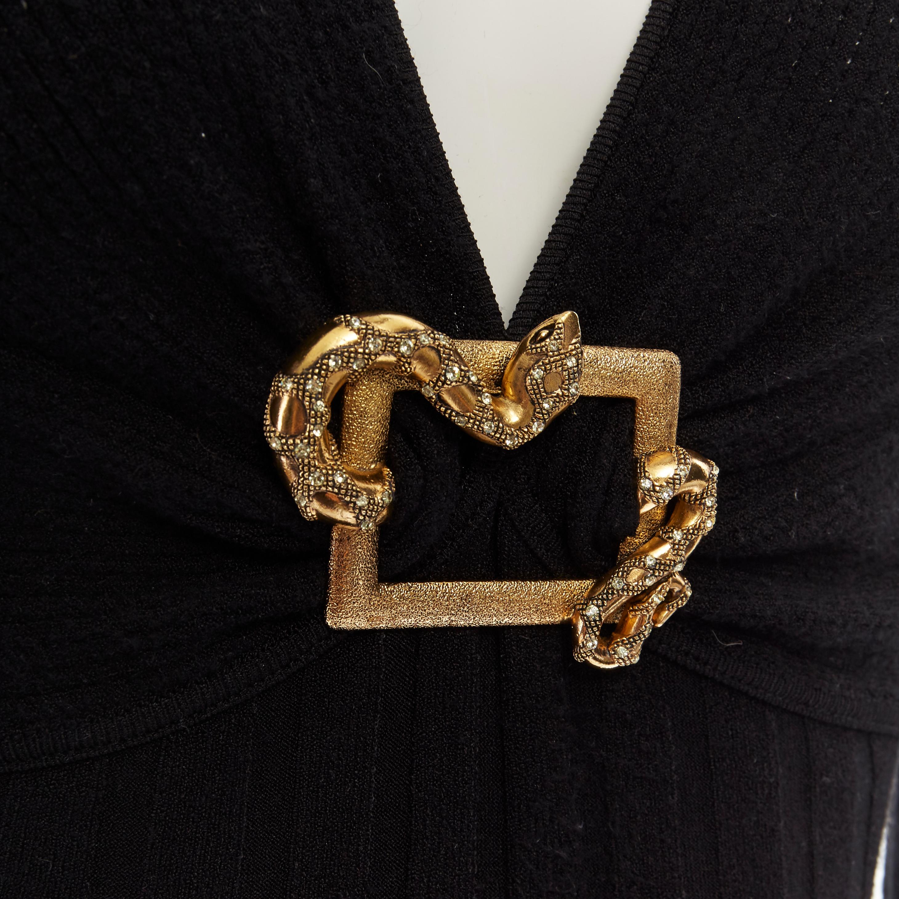 vintage ROBERTO CAVALLI black ribbed gold crystal buckle plunge sweater IT38 XS 
Reference: MYSD/A00019 
Brand: Roberto Cavalli 
Designer: Roberto Cavalli 
Material: Polyester 
Color: Black 
Pattern: Solid 
Extra Detail: Ribbed knit. Contrast