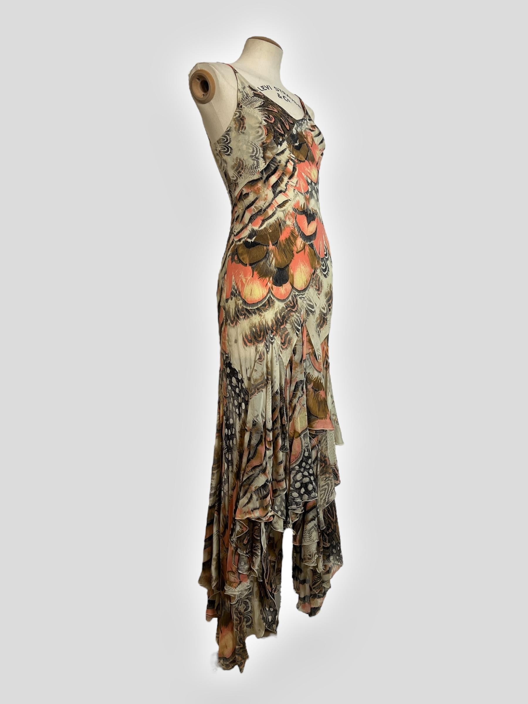 Immerse yourself in the bohemian glamour of Roberto Cavalli’s Spring 2004 runway with this feather-print dress. The design features a ruffle detail cascading from a flattering V-neckline, creating a soft, feminine touch. A draped fit through the