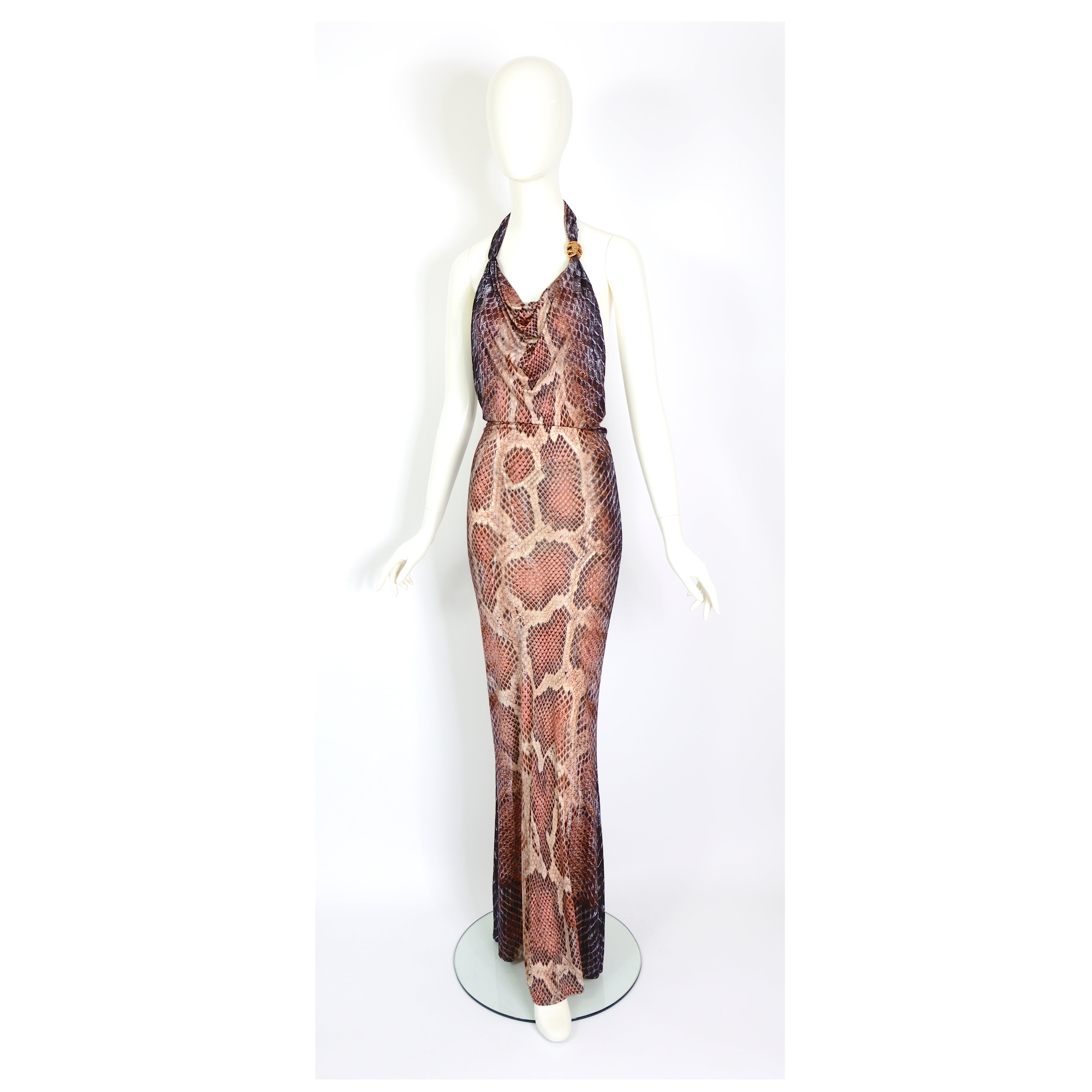Stunning Vintage Roberto Cavalli early 2000s pink, salmon, brown, and cream phyton print slinky rayon/elastane viscose long dress.
Attached phyton brooch
Italian size 40
Excellent condition