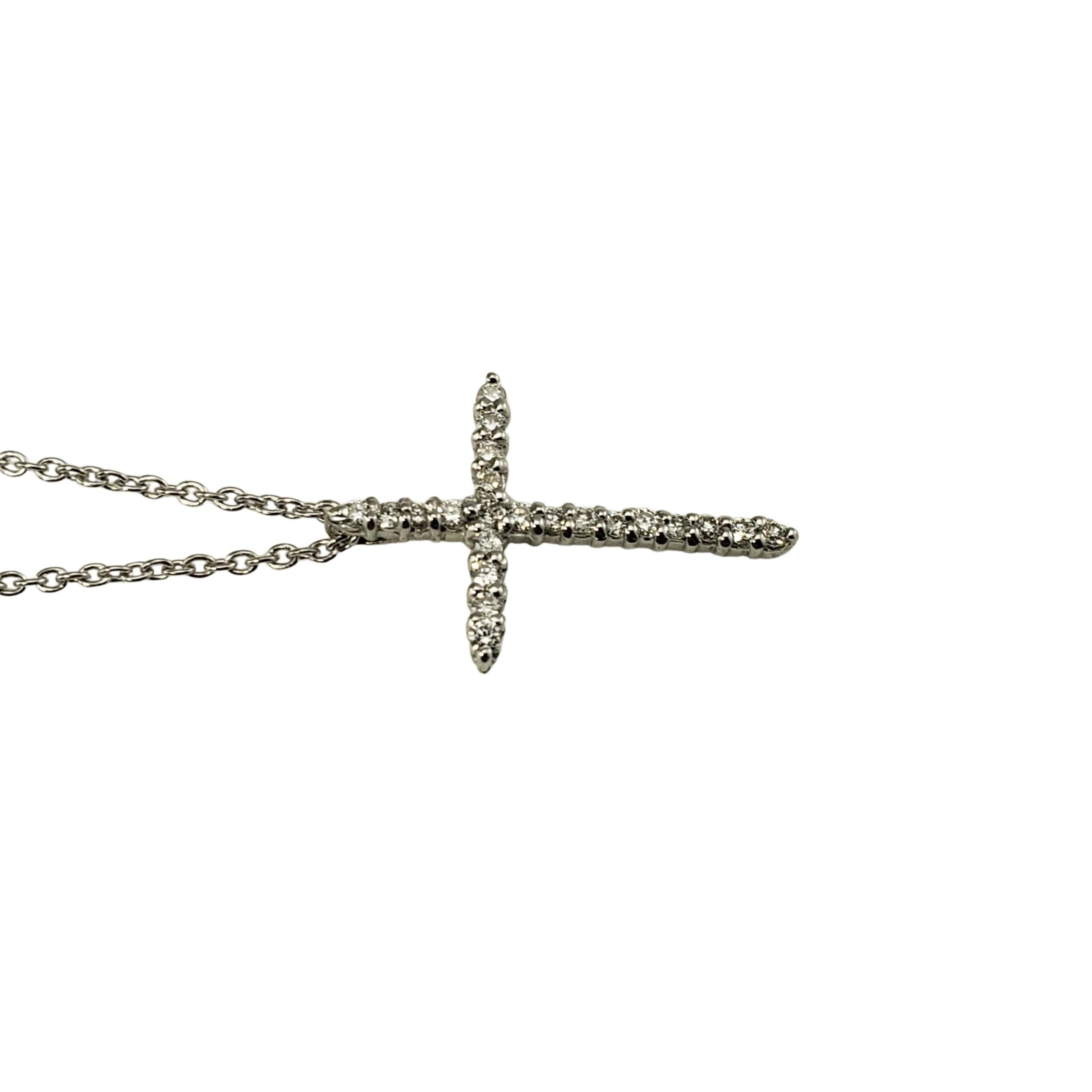 Vintage Roberto Coin 18 Karat White Gold Diamond Cross Pendant Necklace-

This sparkling cross pendant features 22 round brilliant cut diamonds and suspends from a classic white gold chain.

Approximate total diamond weight:  .10 ct.

Diamond color: