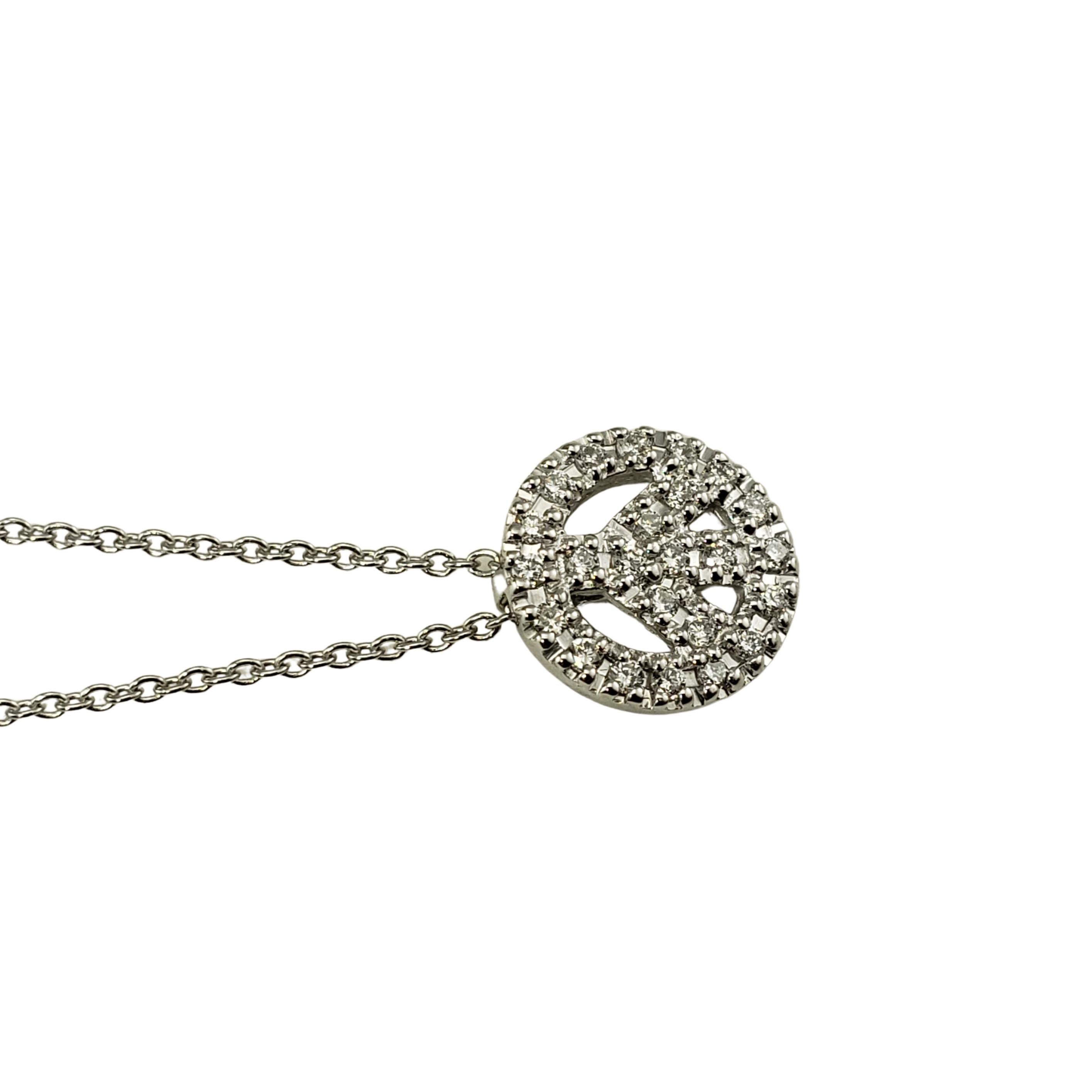 Vintage Roberto Coin 18 Karat White Gold Diamond Peace Sign Pendant Necklace-

This sparkling peace sign pendant features 24 round brilliant cut diamonds suspended from a classic 18K white gold necklace.  Signature Roberto Coin ruby on back of