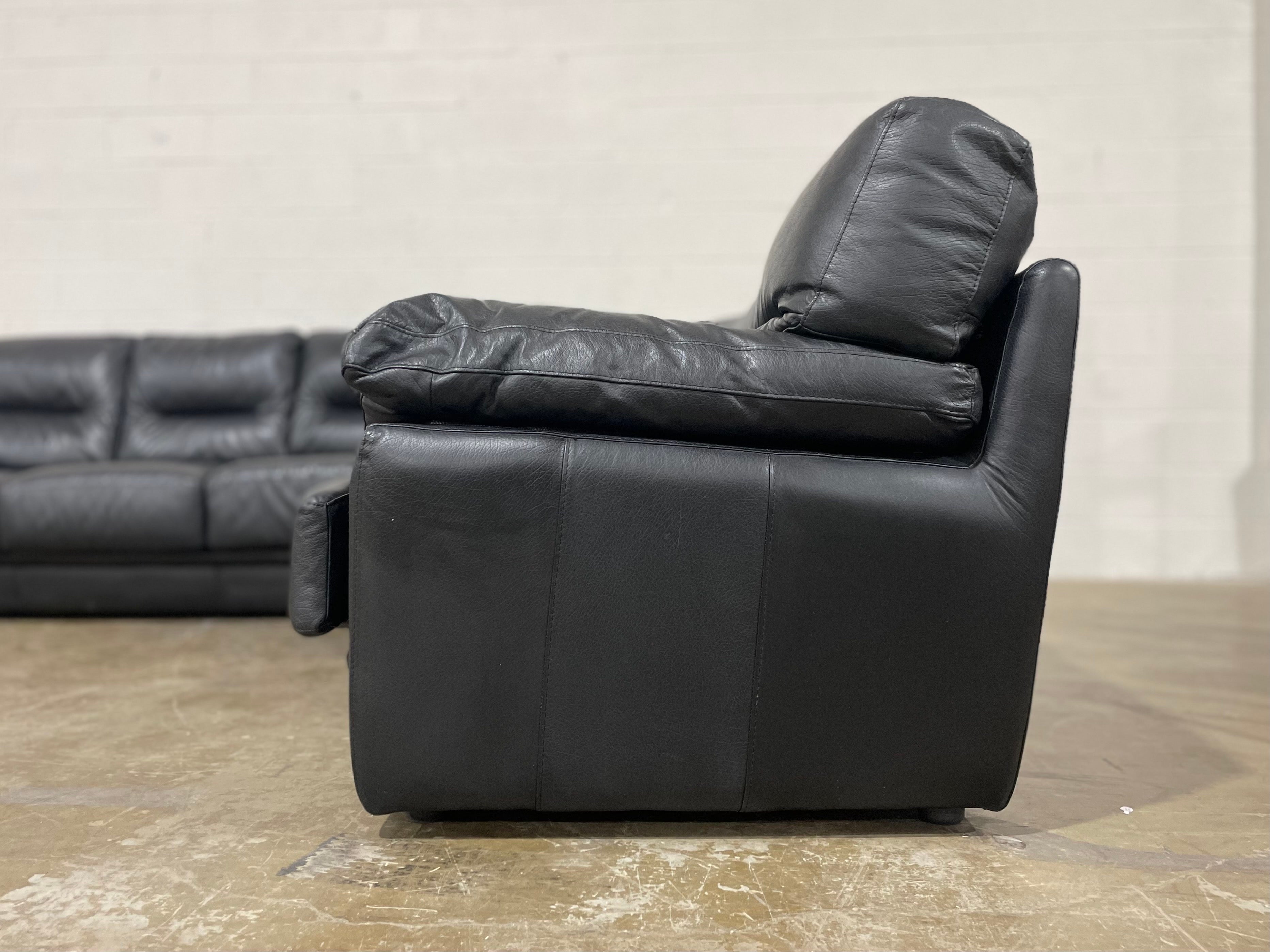 Post modern Roche Bobois black leather sectional sofa, Purchased new in 1992. Excellent condition - very rarely, if ever used. Goose down back cushions. Full grain leather is soft and supple, it has been cleaned and conditioned and is ready for use.