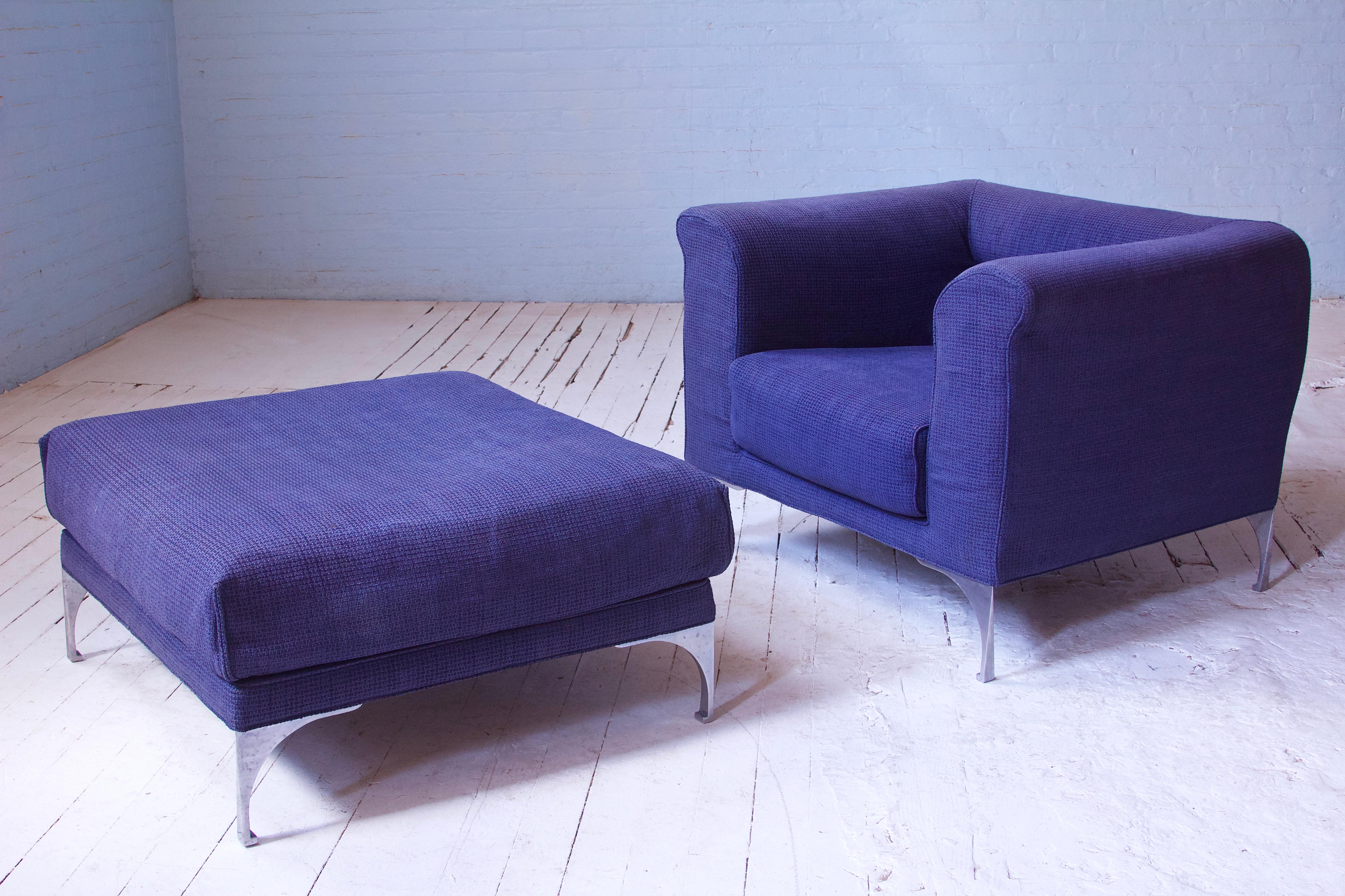 A commodious and attractive lounge chair and ottoman by Roche Bobois in blue wool and chrome legs. Very comfortable and supportive set with unique modern cast and polished chrome legs. Nice subtle tapering to the silhouette of the lounge chair