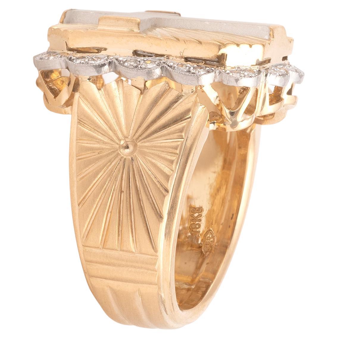 Bishop's ring in platinum and 18kt yellow gold adorned with a large rock-crytal cross on a background of radiant decoration with cut sides in a scalloped entourage of eight-eight cut diamonds. The shoulders with a background of radiant
