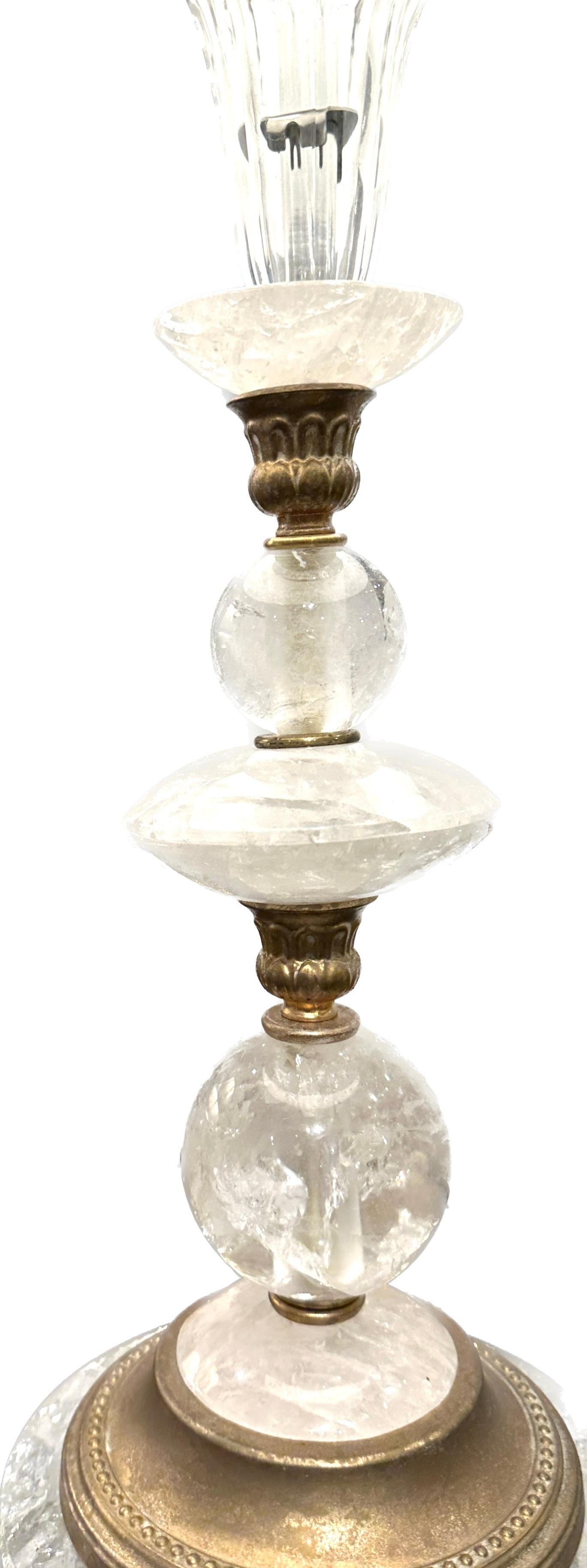 Vintage rock Crystal table lamp with round gilt base, spaced between with gilt metal decorative accent trims.  Finished with rock Crystal finial.
17”  to the rock Crystal.  Shade not included.