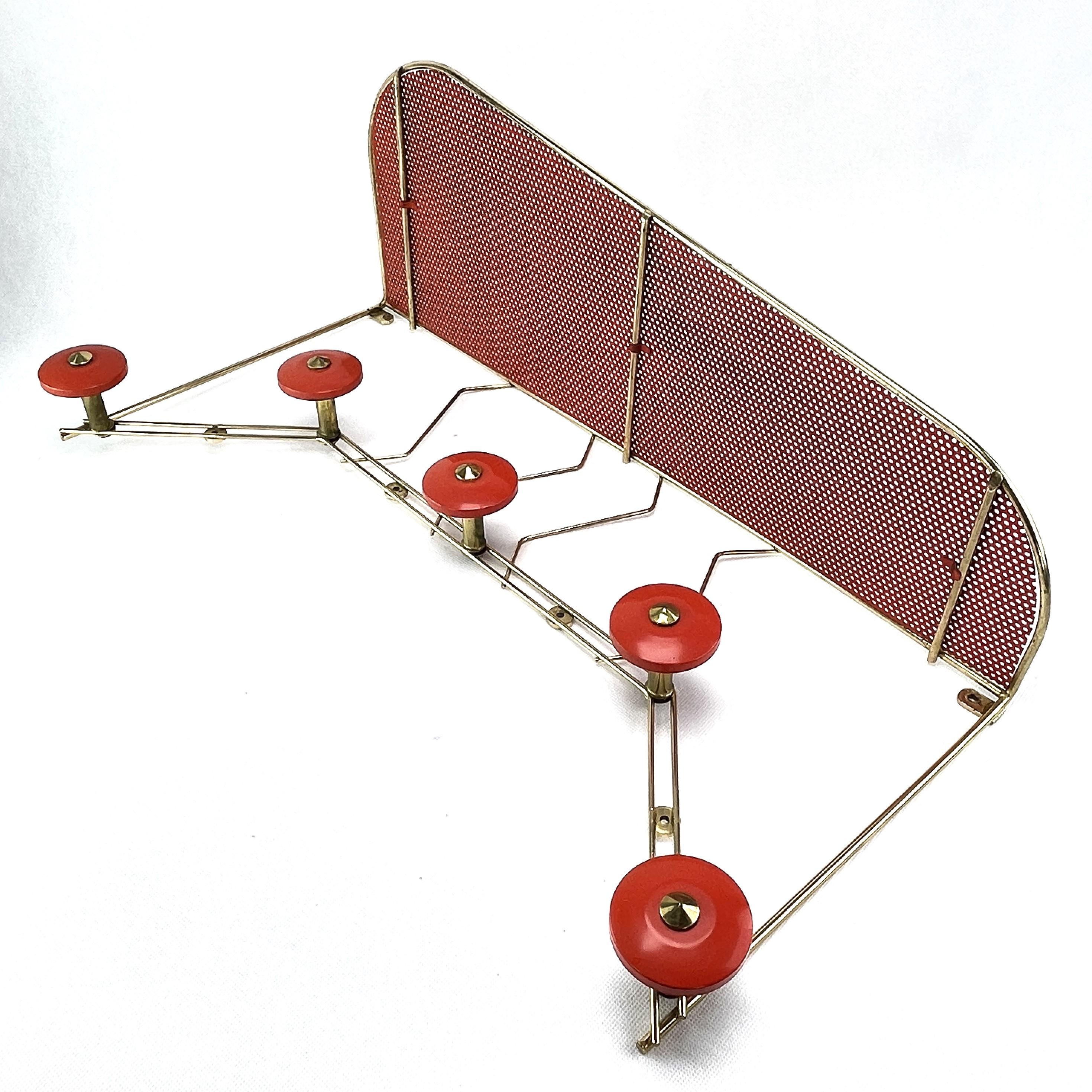 Wall coat rack rockabilly- 1950s.

The french wall coat rack is out of the 1950s period. The wardrobe is an original of its time and it still impresses with its beautiful shape in the Rockabilly style.

The red and gold wardrobe weights 1.9 kg /