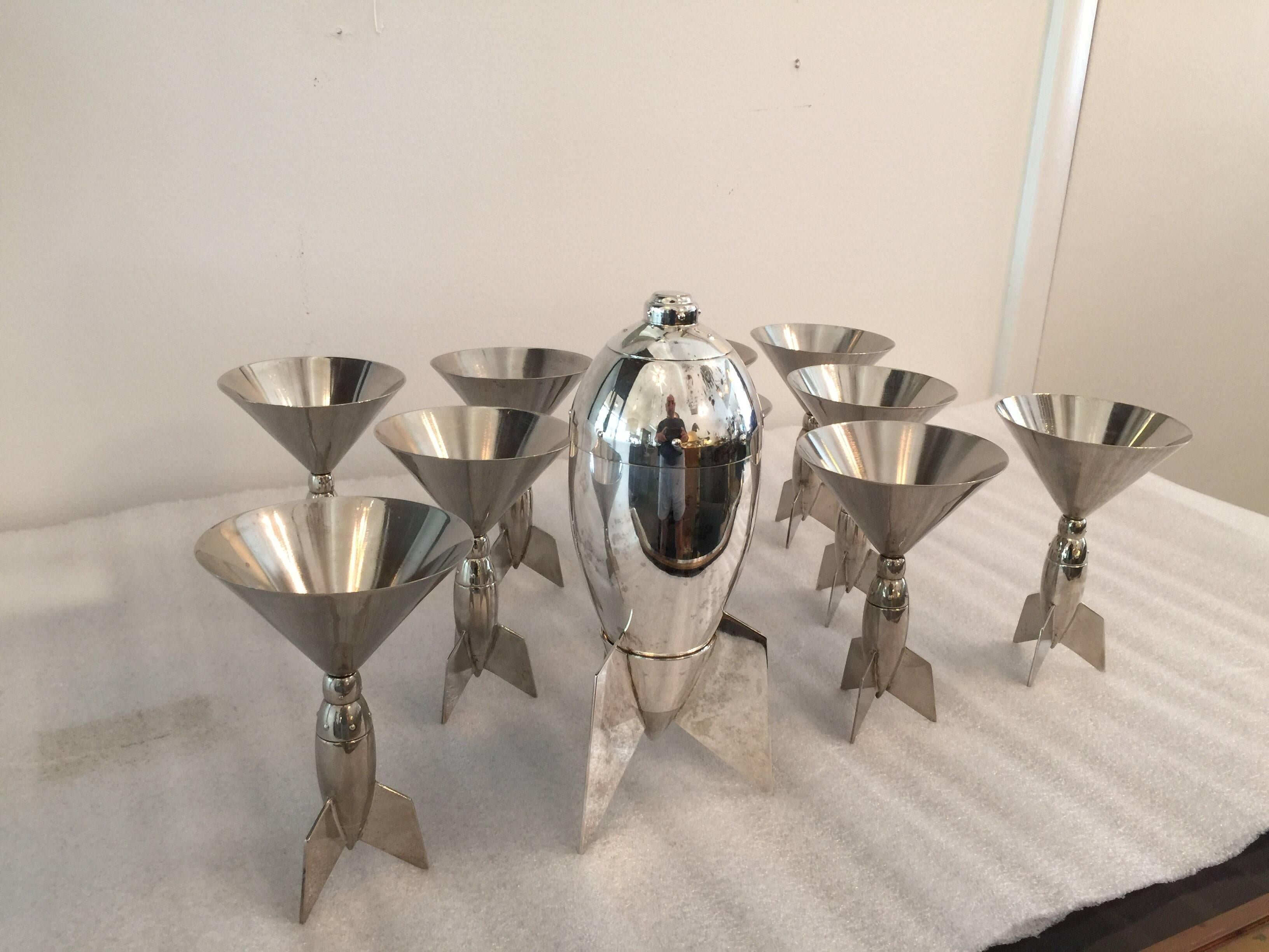 This is a beyond amazing grouping of ten martini glasses with rocket ship design - very Cold War era and rare to find such a large set (ten glasses and shaker). The shaker stands on a base appearing like a rocket. Signed Godinger, very rare! 