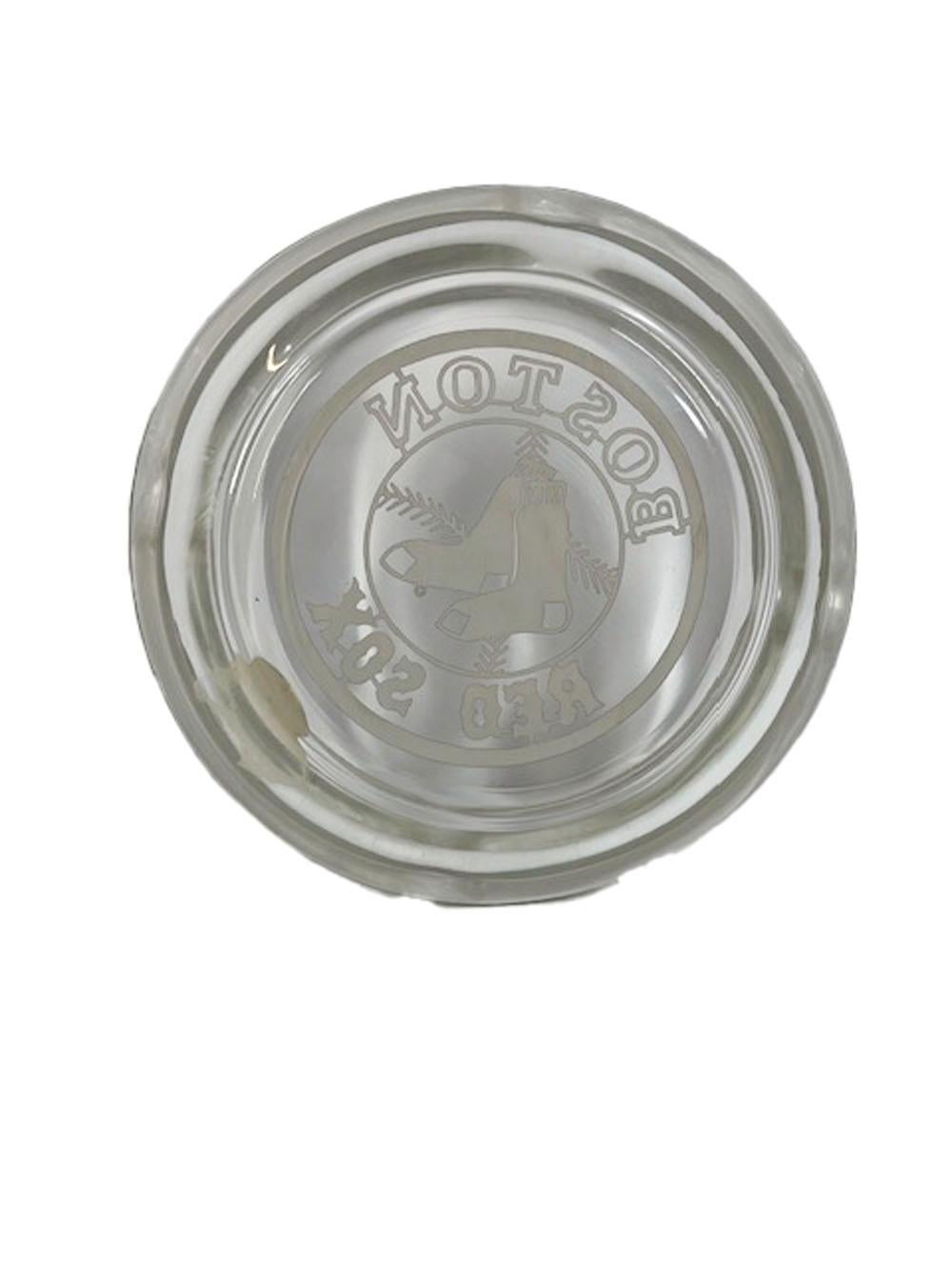 Vintage sterling silver overlay ashtray by Rockwell Silver Company. A circular clear glass ashtray with a silver overlay rim having 4 divots centering a silver overlay image of the Boston Red Sox logo. Retaining its original label.