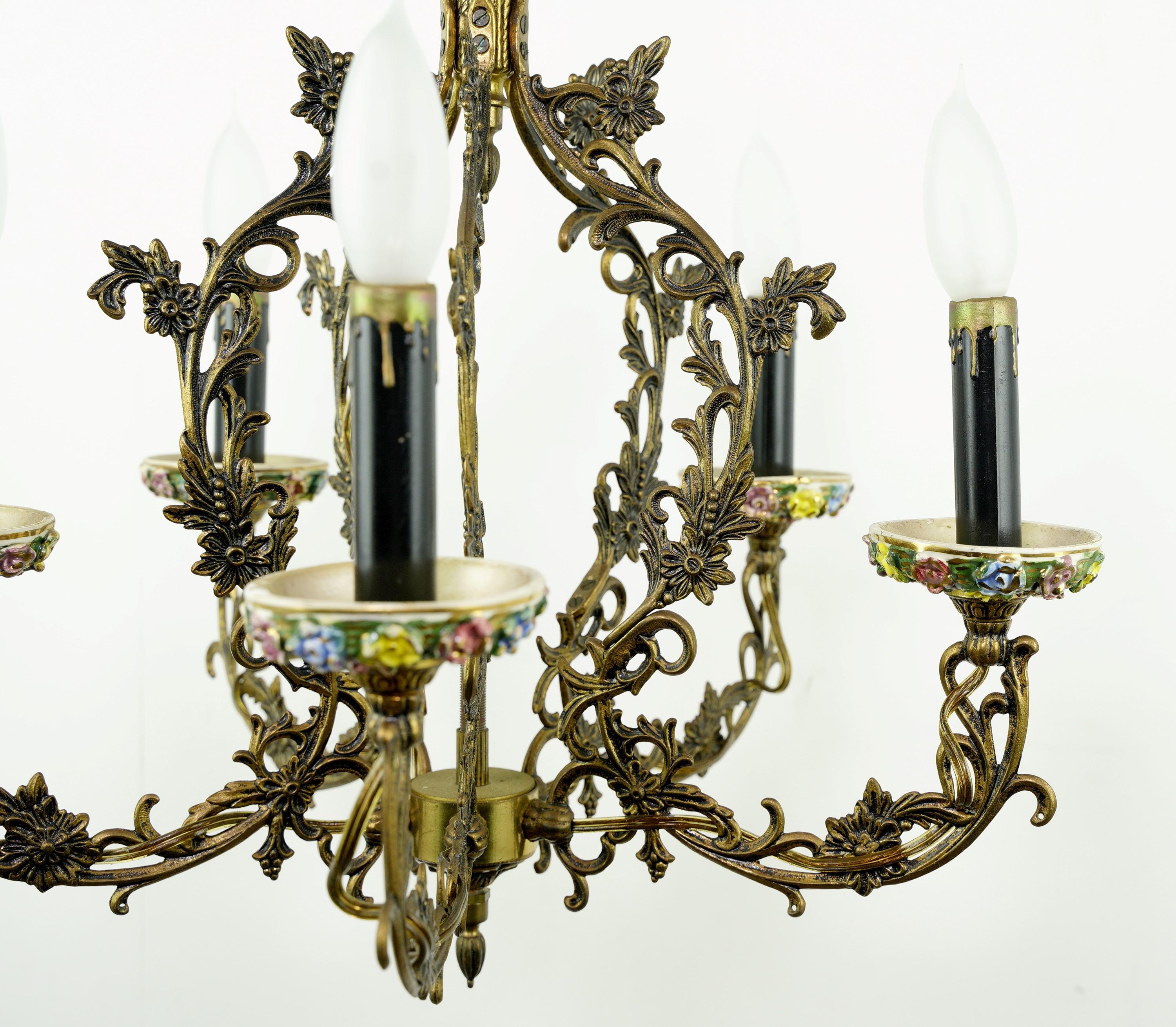 Rococo style five light chandelier featuring a floral design. Hand painted pink, blue, and yellow colored flowers on the bobeches. Takes 5 standard candelabra light bulbs. Cleaned and restored. Please note, this item is located in our Scranton, PA