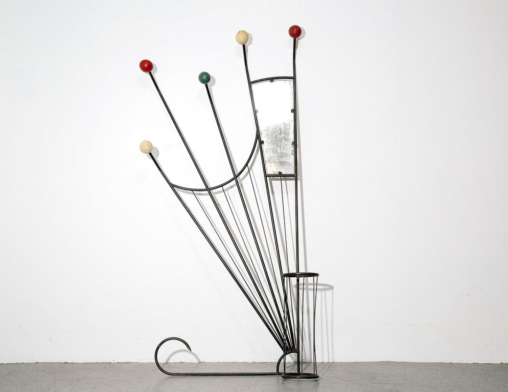Vintage hat rack and mirror produced in the 1950s by French designer Roger Feraud. Sunburst design topped with primary colored wood balls. A jack-of-all-trades design which integrates a mirror and umbrella as well.