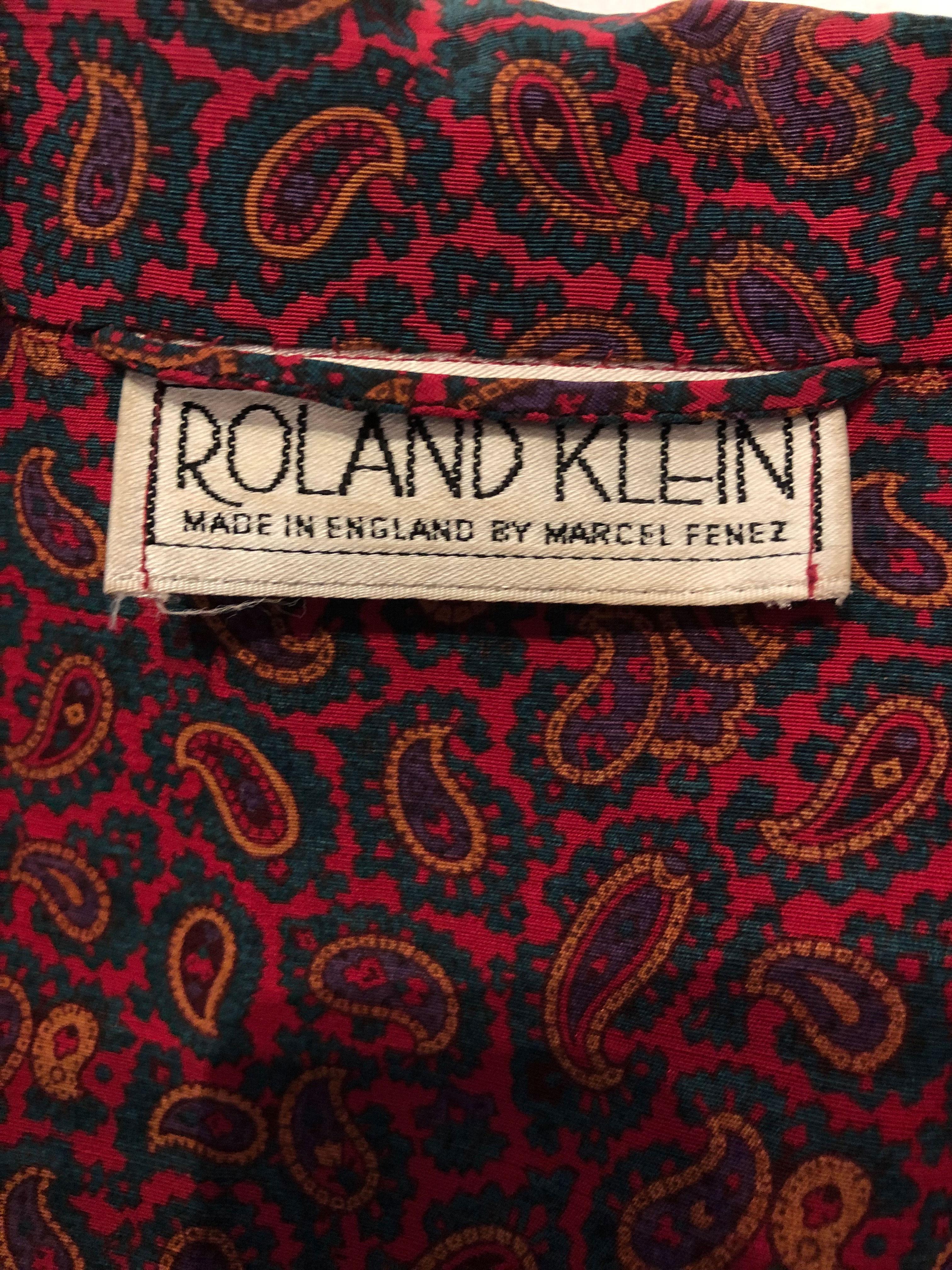 A great vintage jacket by Roalnd Klein. In a silk /wool mix , the jacket is  a mix of red , green and purple. It has a central one button opening , with a pocket either side at hip leval , and one breast pocket on the left hand side.